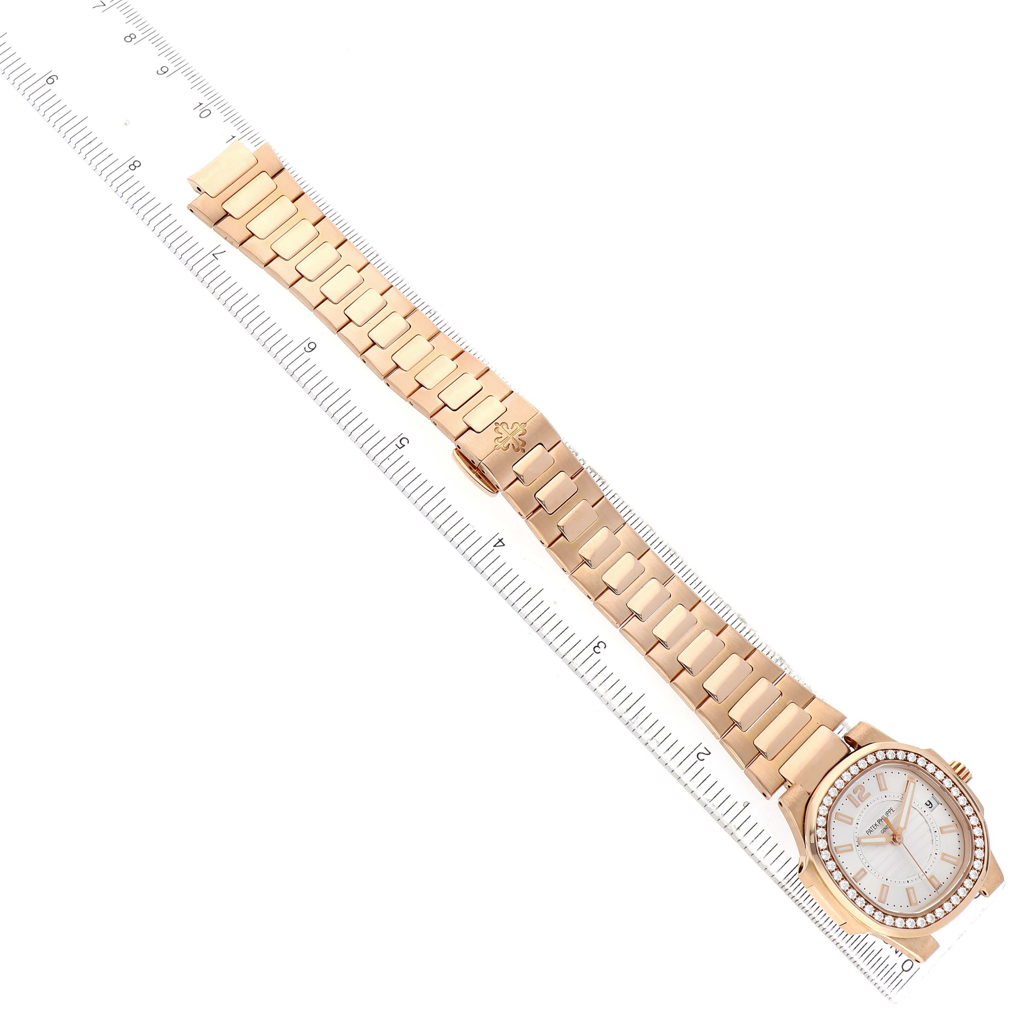 The Patek Philippe Nautilus 7010R Women's Rose Gold Silver Dial watch is shown from above, displaying the full bracelet and case beside a ruler for scale.