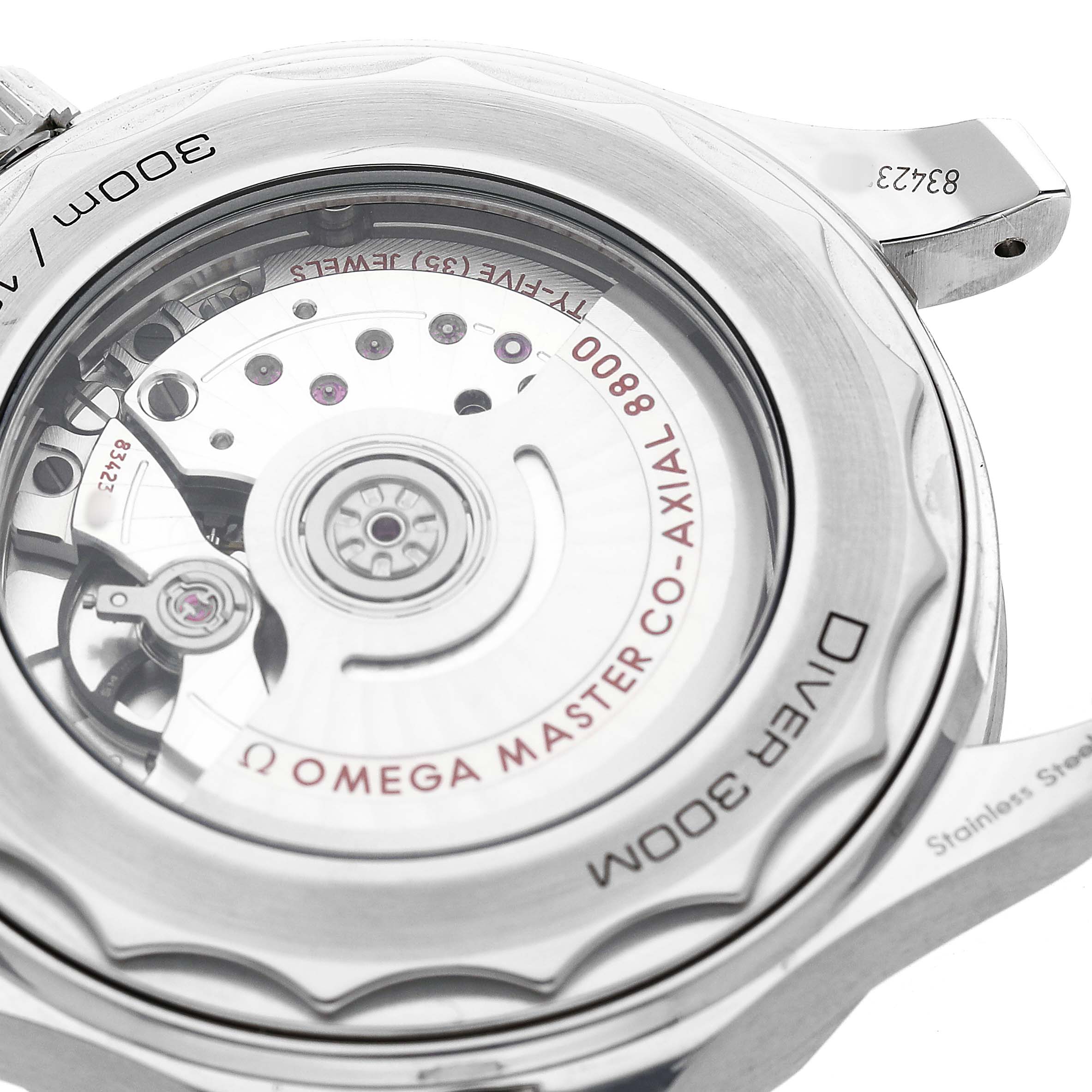 The image shows the case back of an Omega Seamaster 210.30.42.20.04.001 Men's Stainless Steel White Dial, revealing the movement and the "Diver 300M" engraving.