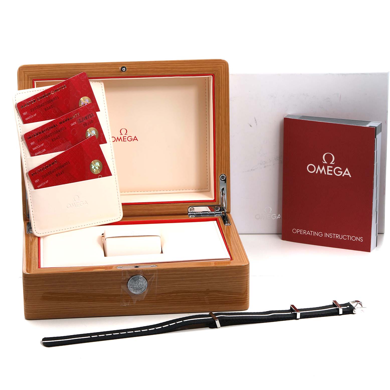 The image shows the open box of an Omega Seamaster 210.30.42.20.04.001 Men's Stainless Steel White Dial, with warranty cards, operating instructions, and an extra strap.