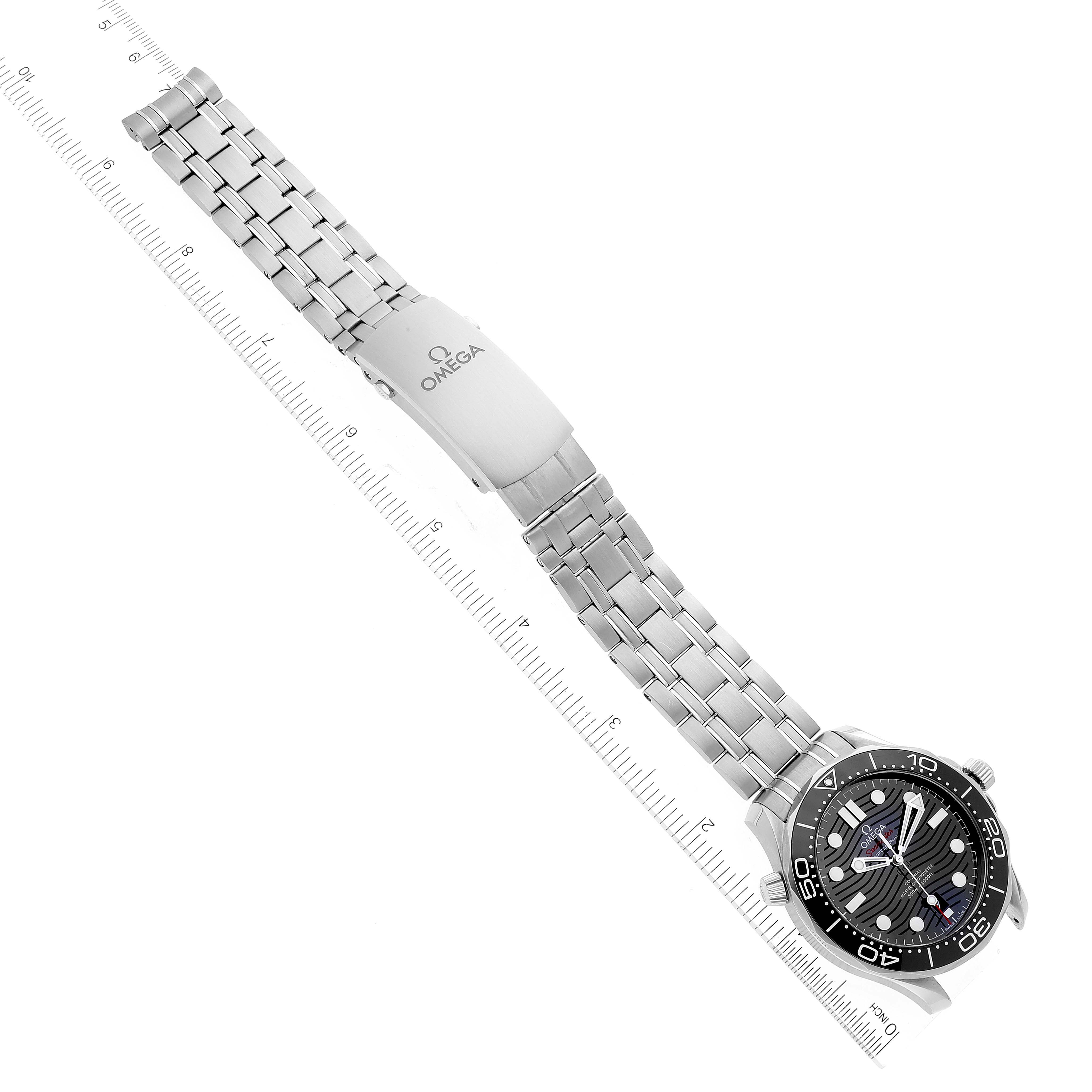 The image shows a top-down view of an Omega Seamaster 210.30.42.20.01.001 Men's Stainless Steel Black Dial 210.30.42.20.01.001 Men's Stainless Steel Black Dial watch, highlighting the face, bezel, and metal bracelet with a ruler for scale.