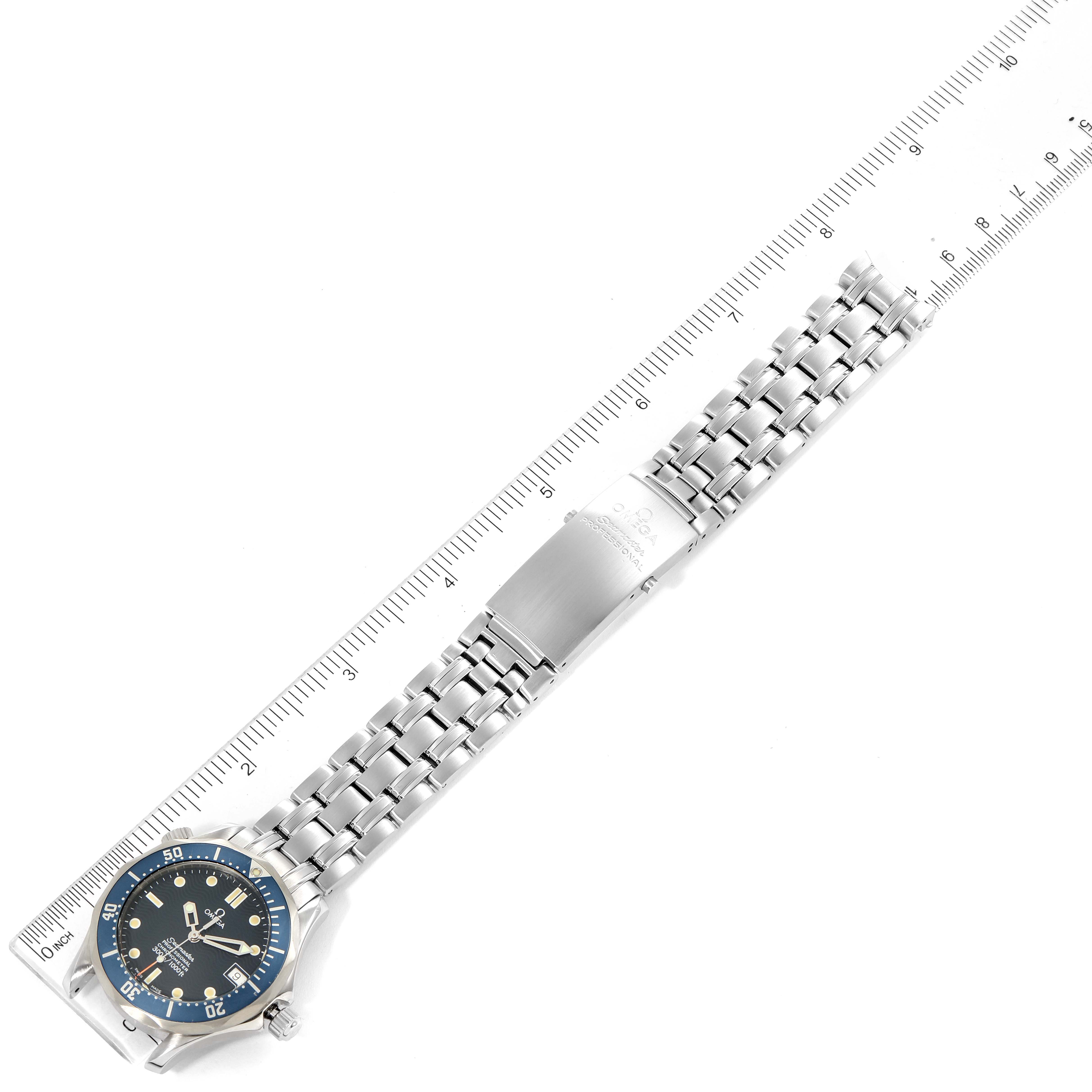 The Omega Seamaster 2551.80.00 Men's Stainless Steel Blue Dial 2551.80.00 Men's Stainless Steel Blue Dial watch is shown from a top-down angle, featuring the full length of the wristband against a ruler for scale.
