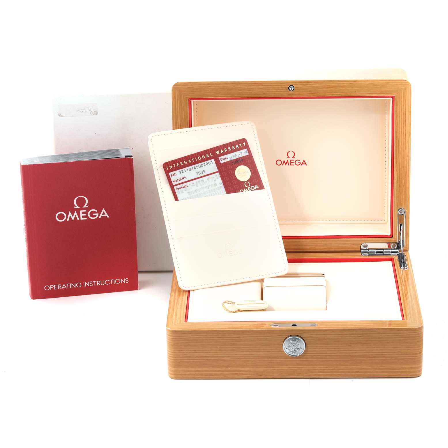 This image shows the packaging and accessories of the Omega Speedmaster 321.10.44.50.02.001 Men
s Stainless Steel Silver Dial 321.10.44.50.02.001 Men
s Stainless Steel Silver Dial, including its box, operating instructions, and warranty card.