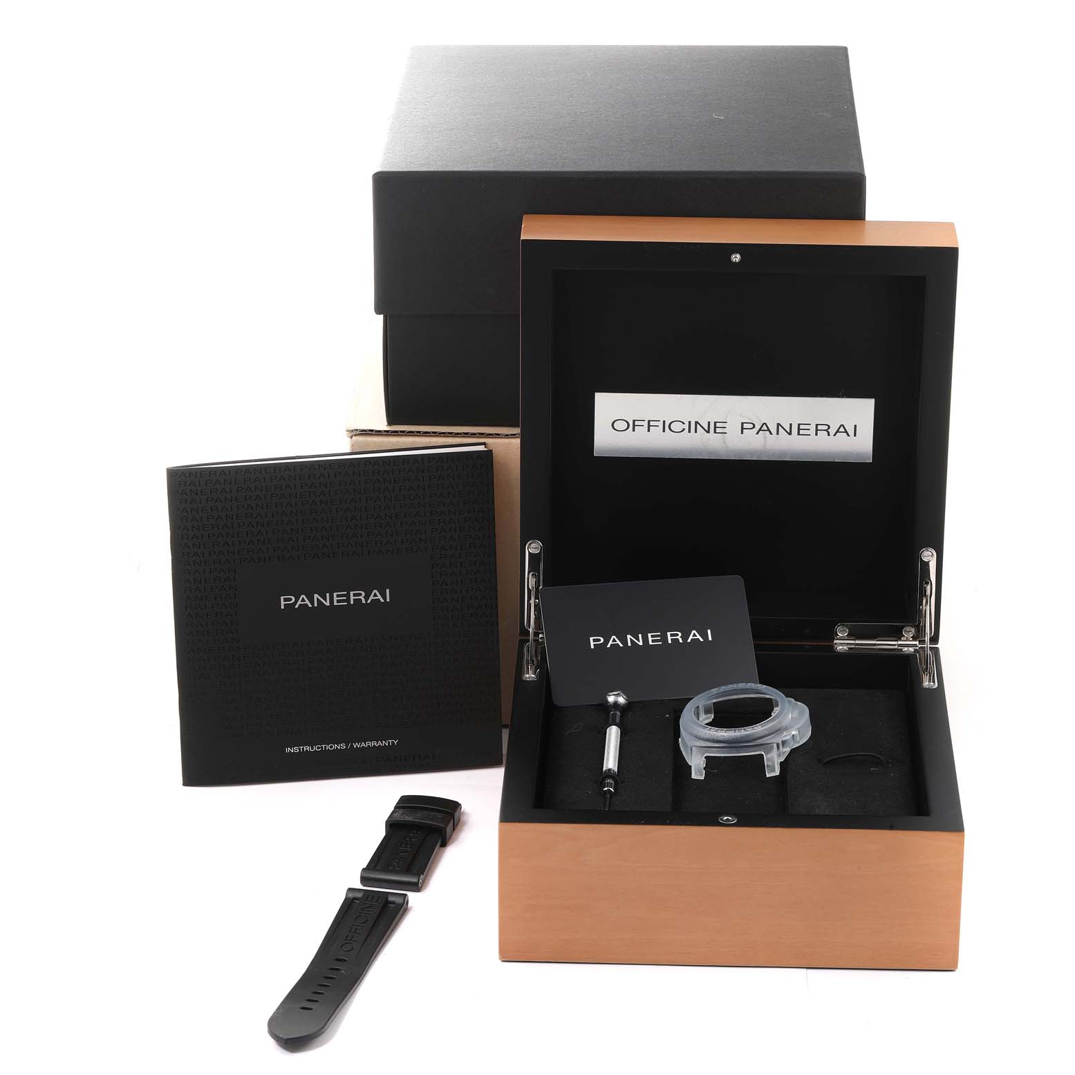 The image shows the packaging and accessories of a Panerai Luminor PAM00660 Men
s Stainless Steel White Dial PAM00660 Men
s Stainless Steel White Dial watch, including a strap, tool, instruction booklet, and storage box.