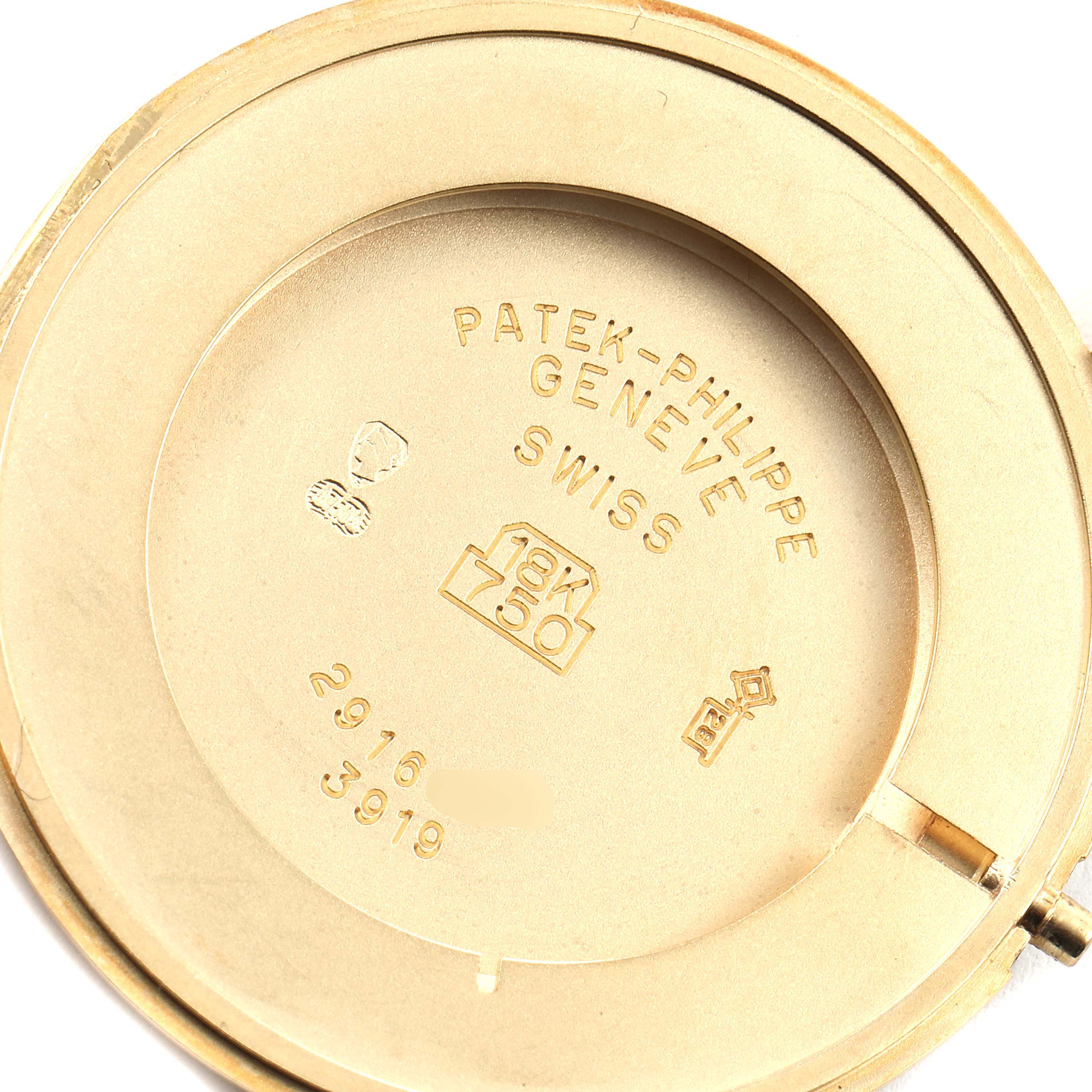 This image shows the inner case back of a Patek Philippe Calatrava 3919 Men's Yellow Gold White Dial 3919 Men's Yellow Gold White Dial watch, featuring hallmark stamps and engravings.
