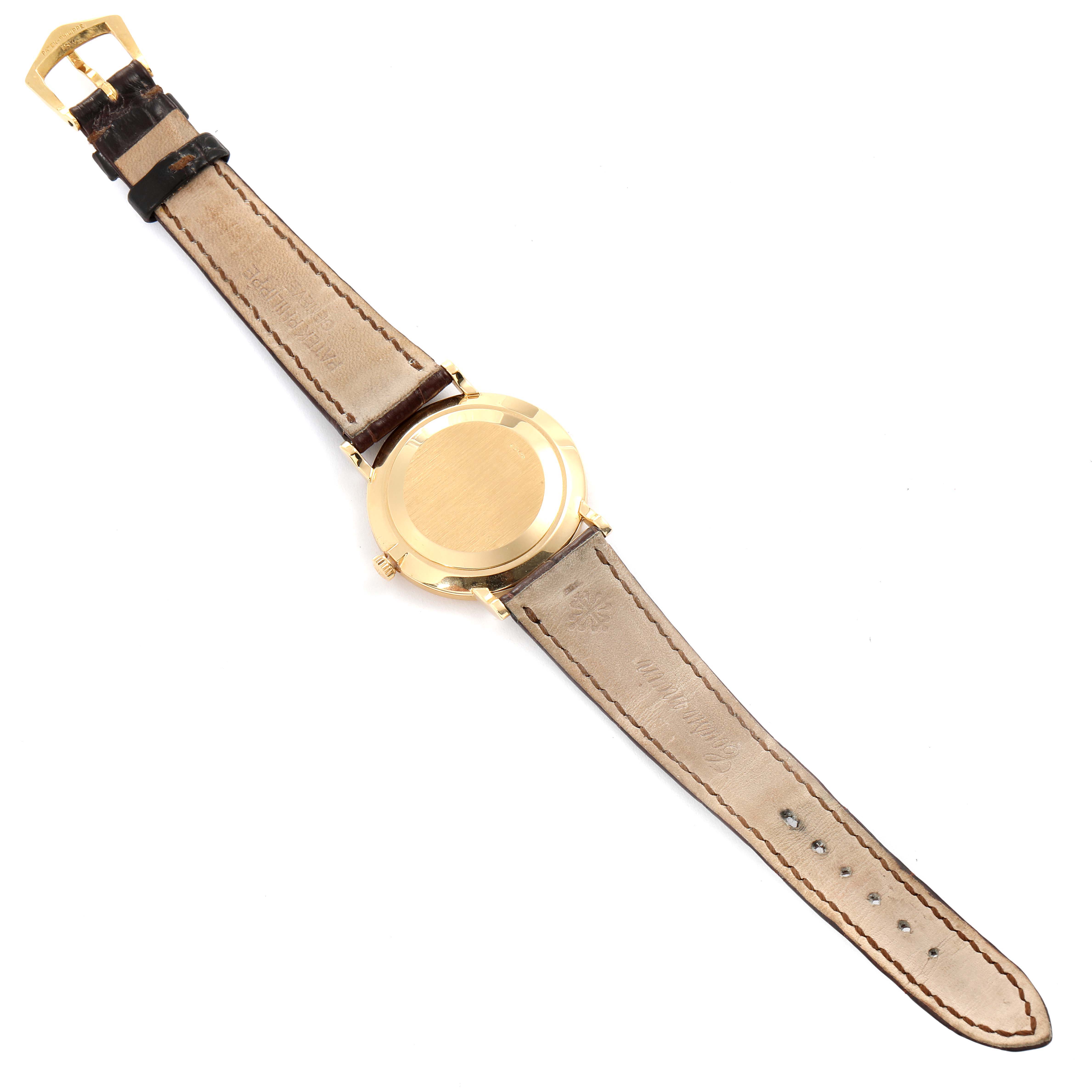 The image shows the back view of a Patek Philippe Calatrava 3919 Men's Yellow Gold White Dial 3919 Men's Yellow Gold White Dial watch, highlighting the leather strap and gold casing.