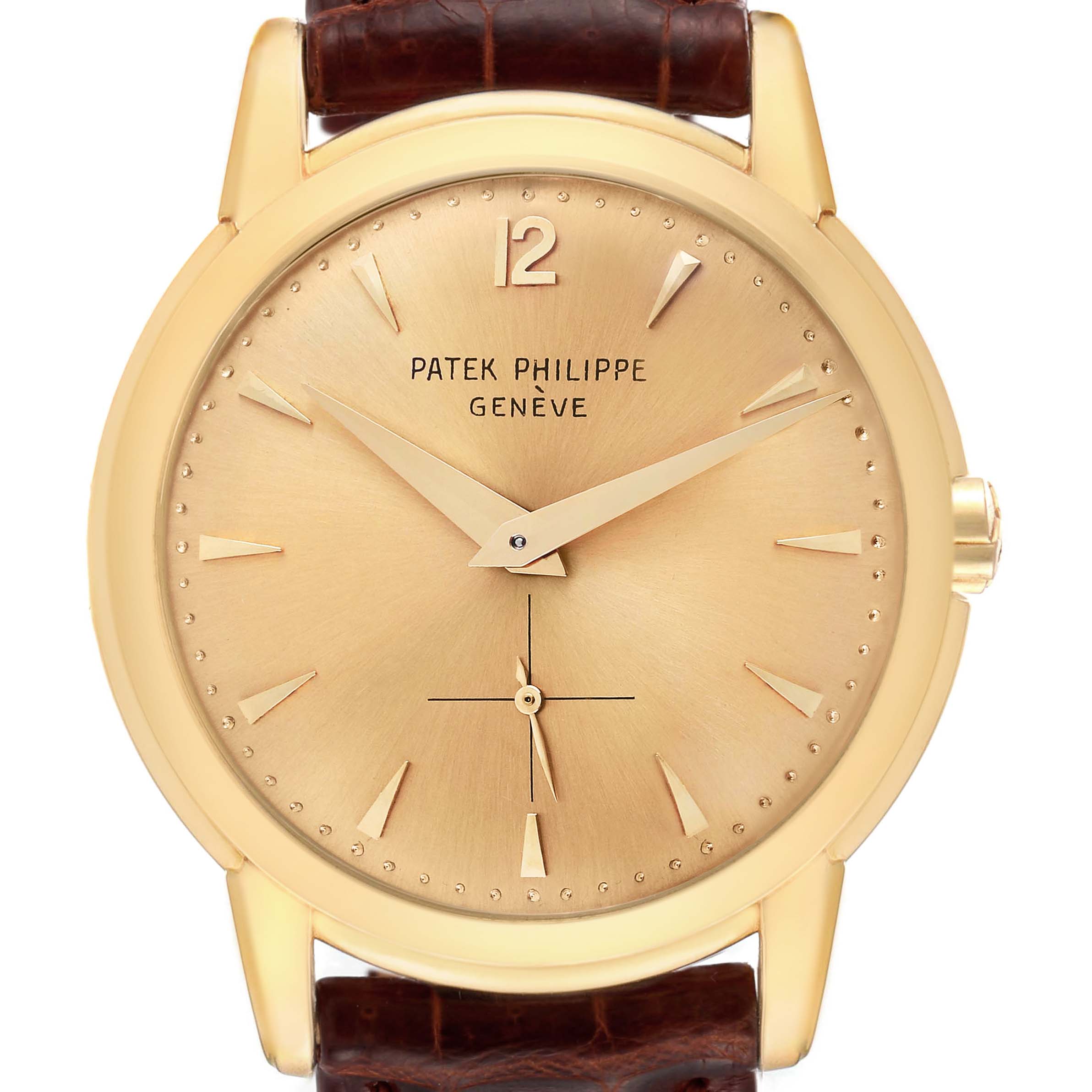 The image shows a front view of a Patek Philippe Calatrava 2551J Men
s Yellow Gold Champagne Dial 2551J Men
s Yellow Gold Champagne Dial watch, including its dial, hands, and part of the leather strap.