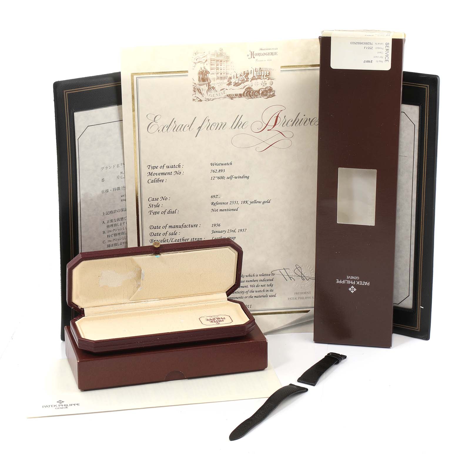 The image shows a Patek Philippe Vintage watch box, a certificate, a leather strap, and packaging materials from a top-down angle.