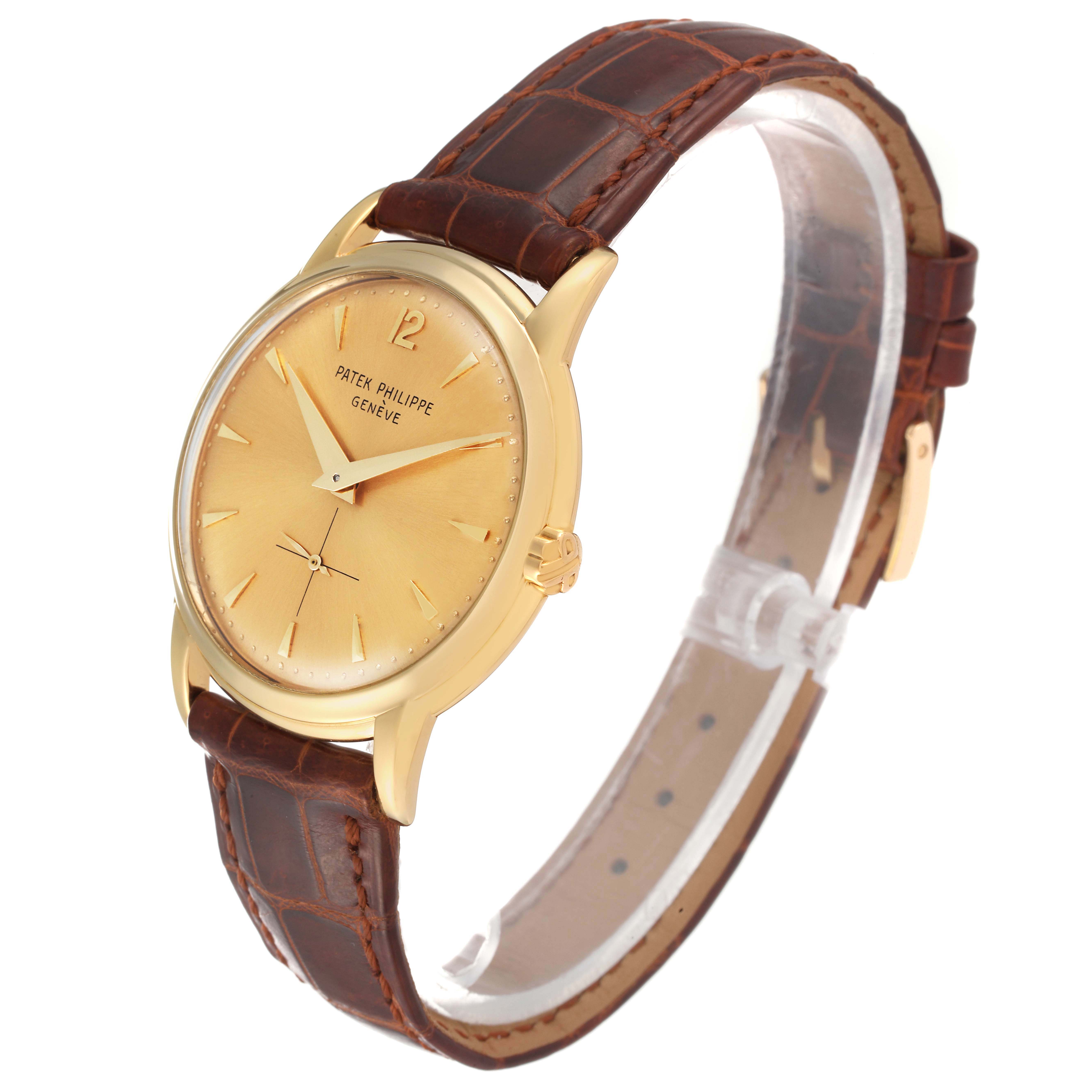 The image shows a side angle view of a Vintage Patek Philippe watch with a brown leather strap and a gold face.