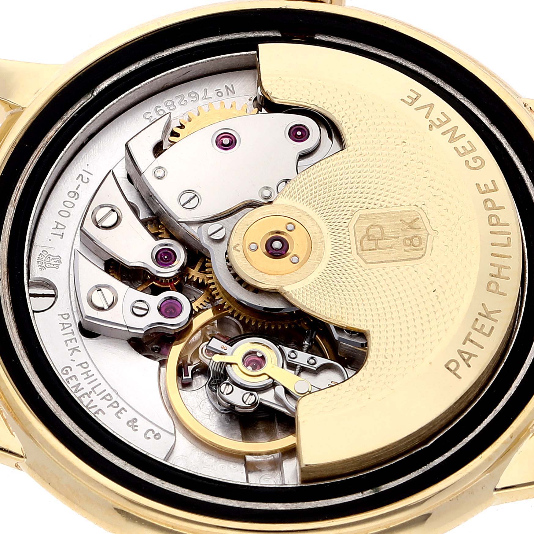The image shows the intricate internal mechanism and the rotor of the vintage Patek Philippe watch from a close-up angle.