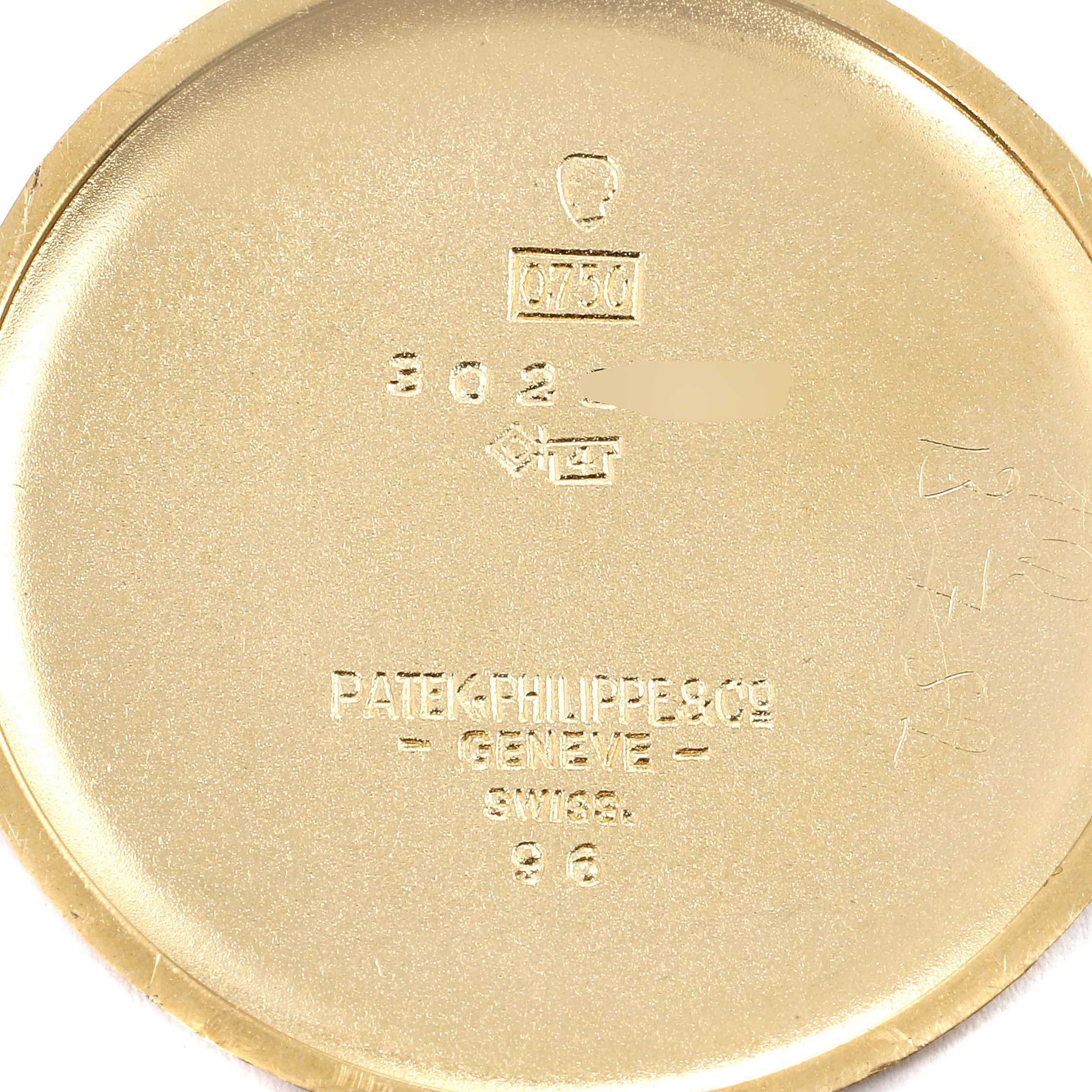 The image shows the inner case back of a Vintage Patek Philippe watch with engravings and hallmarks.