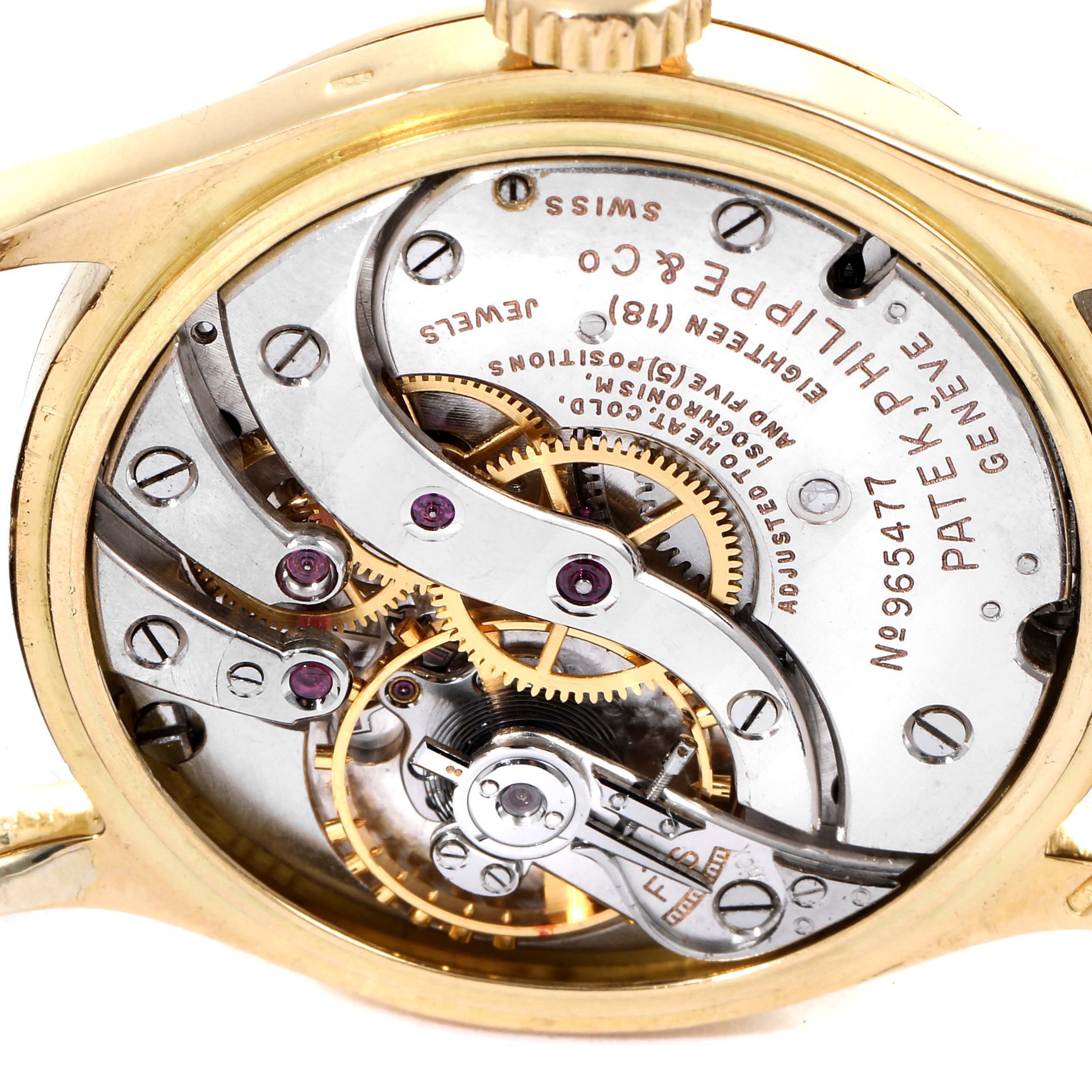 The image shows the internal mechanism and engraved details of a Vintage Patek Philippe watch, viewed from the back.