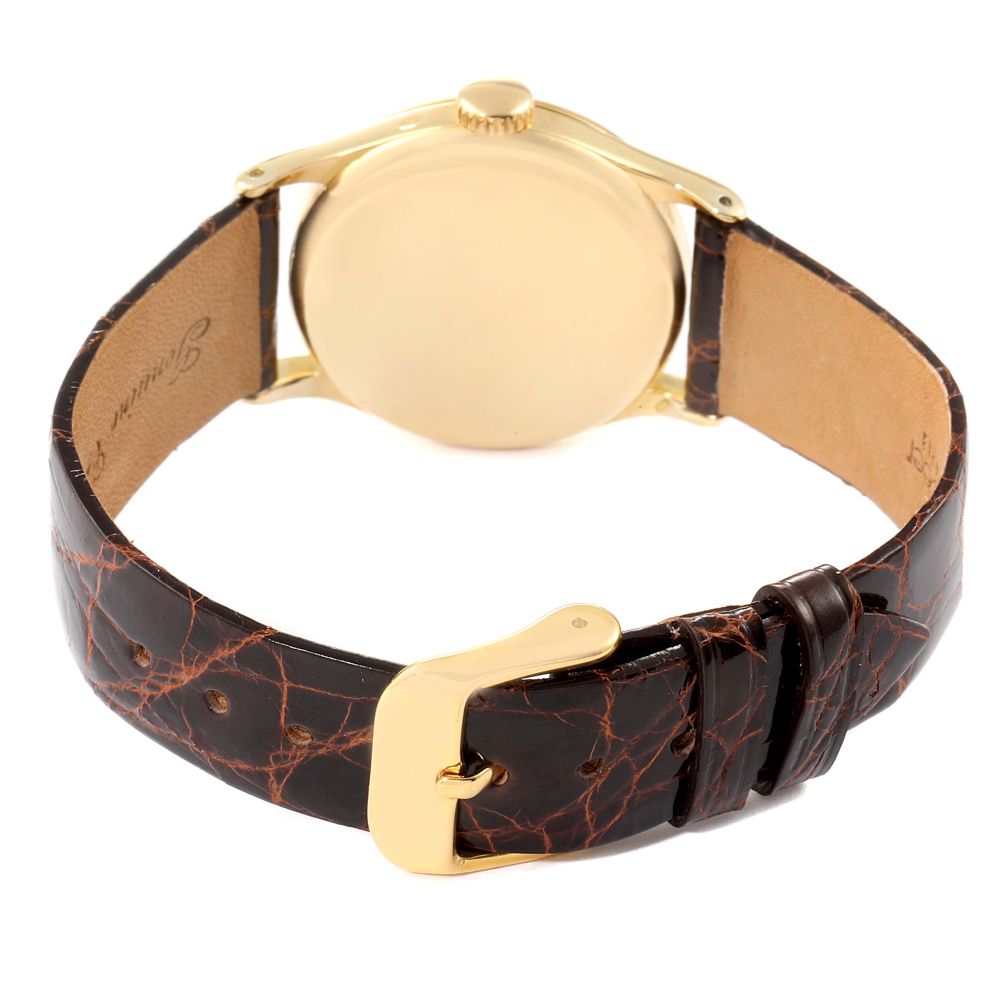 The image shows the back view of a Vintage Patek Philippe watch, highlighting the case back and leather strap with a buckle.