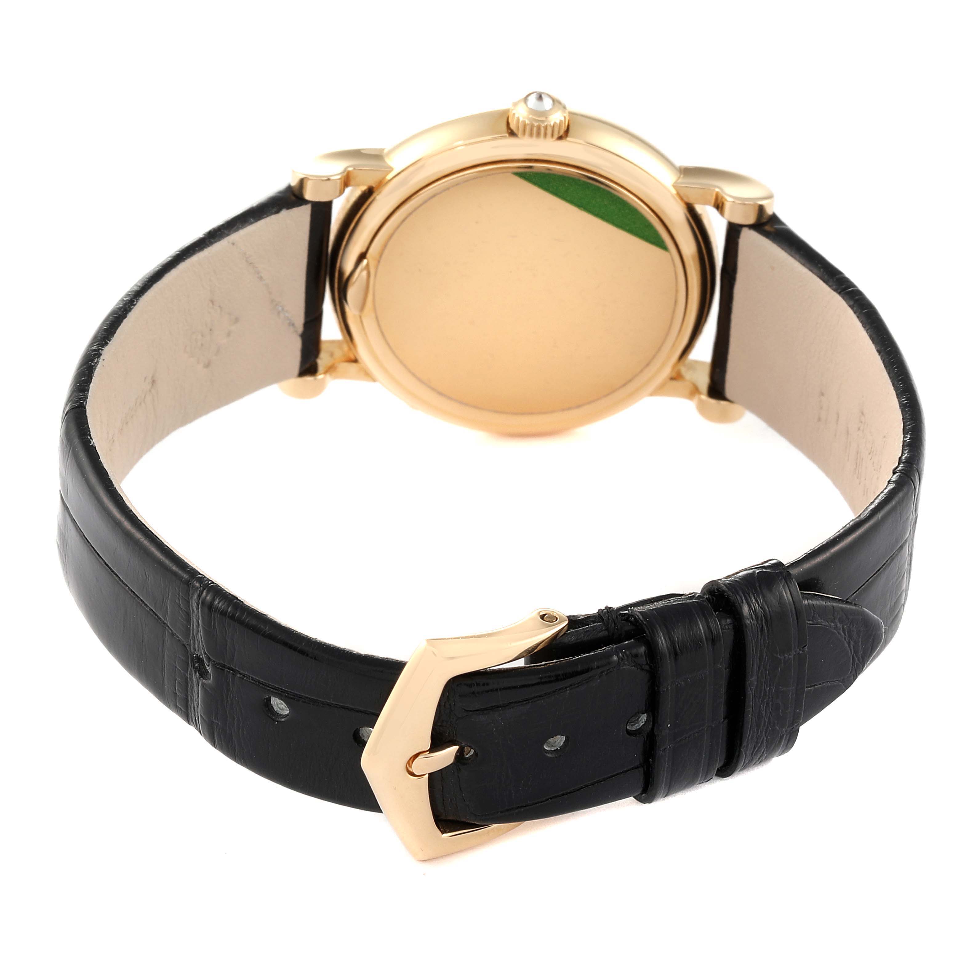 This image shows the back view of a Patek Philippe Calatrava 4858J - 010 Women's Yellow Gold Brown Dial 4858J - 010 Women's Yellow Gold Brown Dial watch, featuring its caseback, crown, and black leather strap with buckle.