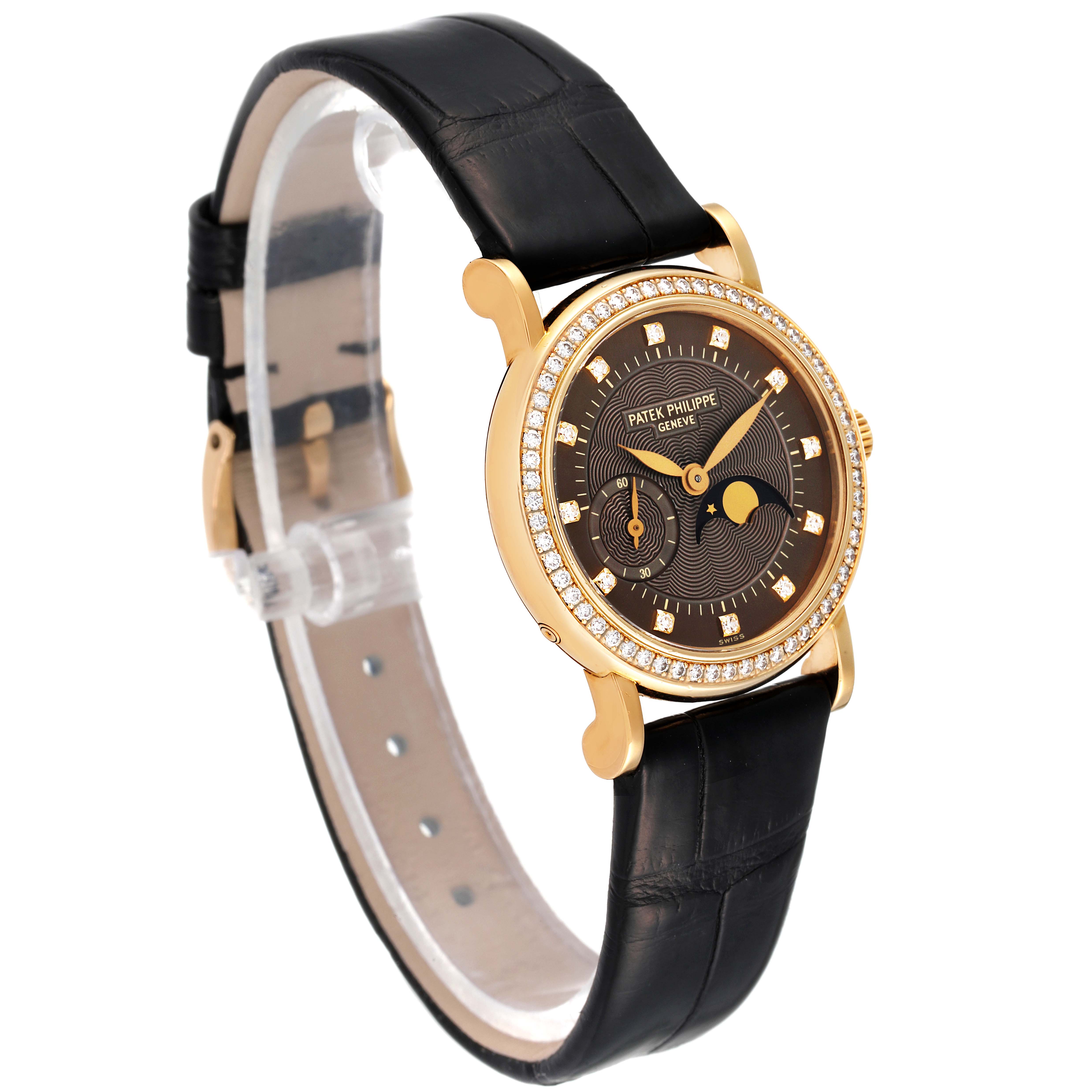 The Patek Philippe Calatrava 4858J - 010 Women's Yellow Gold Brown Dial 4858J - 010 Women's Yellow Gold Brown Dial model watch is shown at an angle, highlighting the dial, bezel, and leather strap.