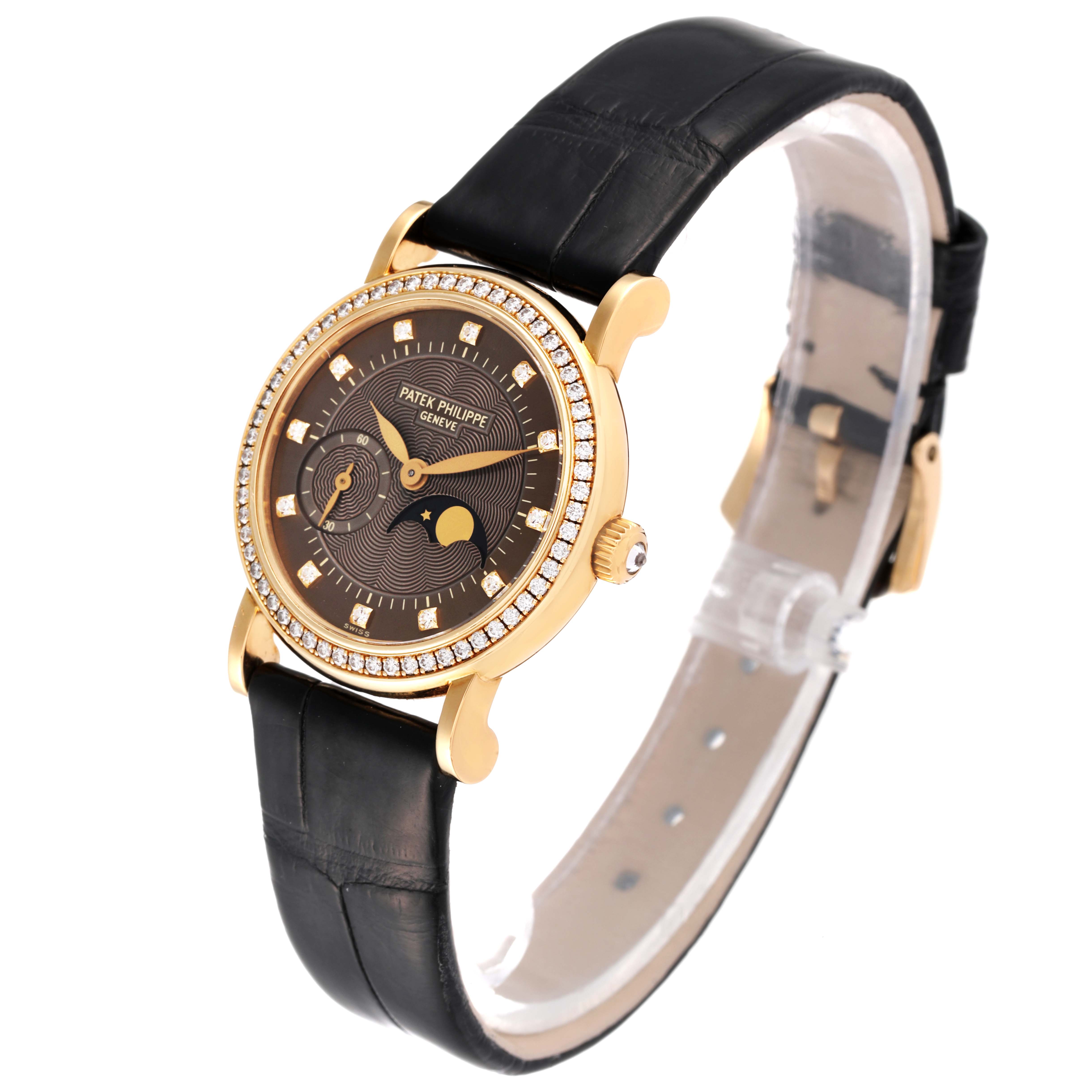 The image shows a Patek Philippe Calatrava 4858J - 010 Women's Yellow Gold Brown Dial 4858J - 010 Women's Yellow Gold Brown Dial watch from an angled side view, highlighting its face, bezel, strap, and crown.