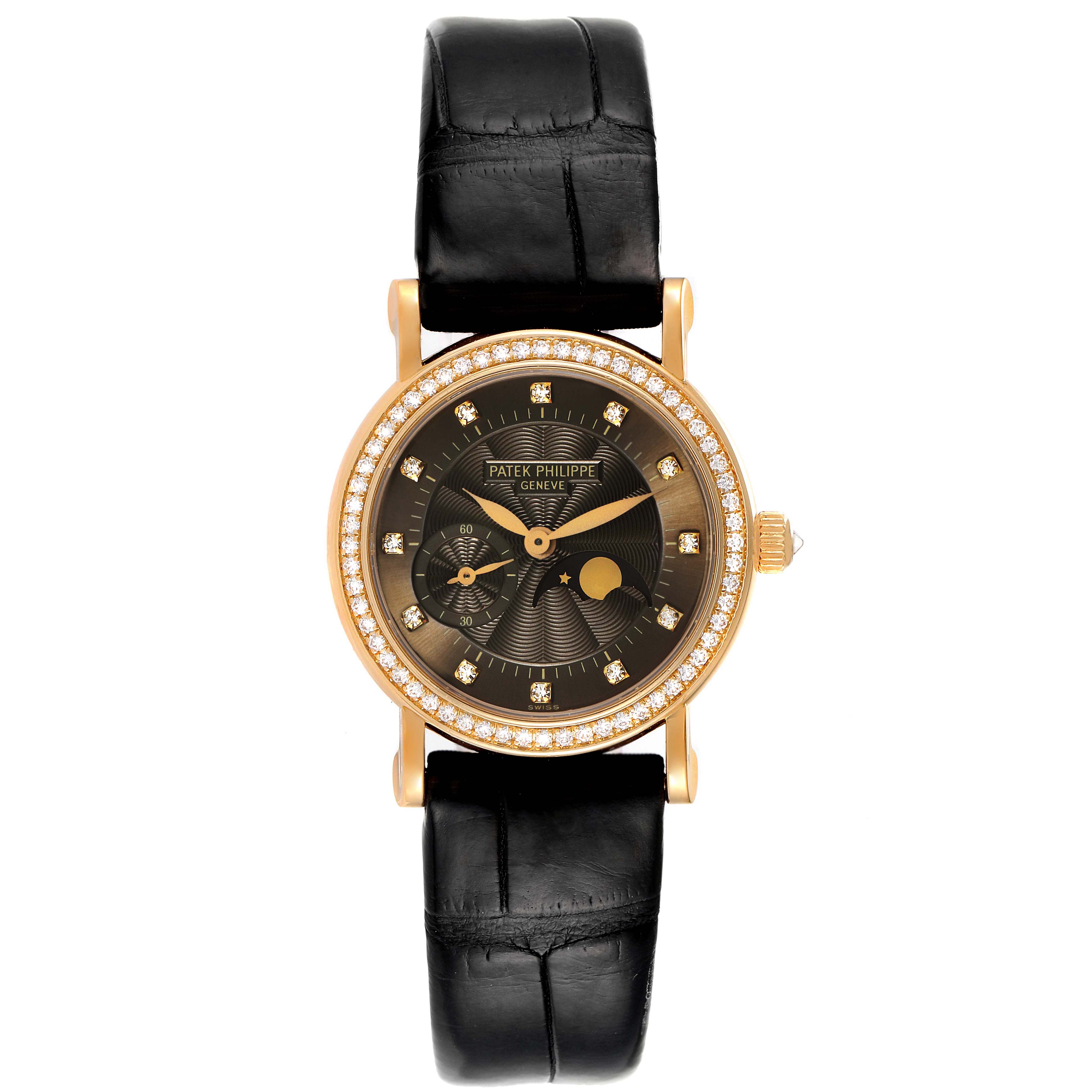 The image shows a front view of a Patek Philippe Calatrava 4858J - 010 Women's Yellow Gold Brown Dial 4858J - 010 Women's Yellow Gold Brown Dial watch with a black strap and a diamond-studded bezel.