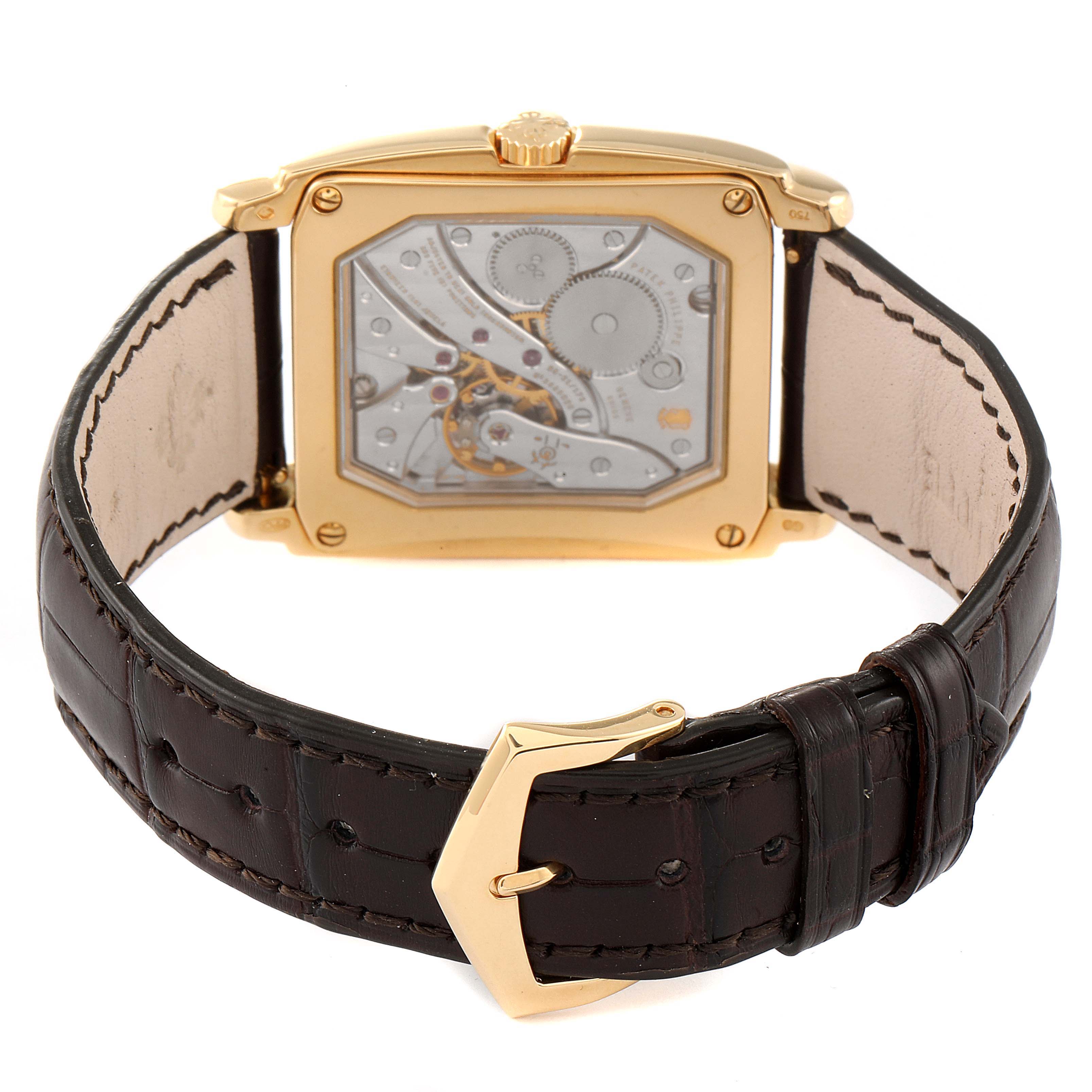 The image shows the back view of a Patek Philippe Gondolo 5124J Men's Yellow Gold Silver Dial 5124J Men's Yellow Gold Silver Dial watch, highlighting its mechanical movement and leather strap.