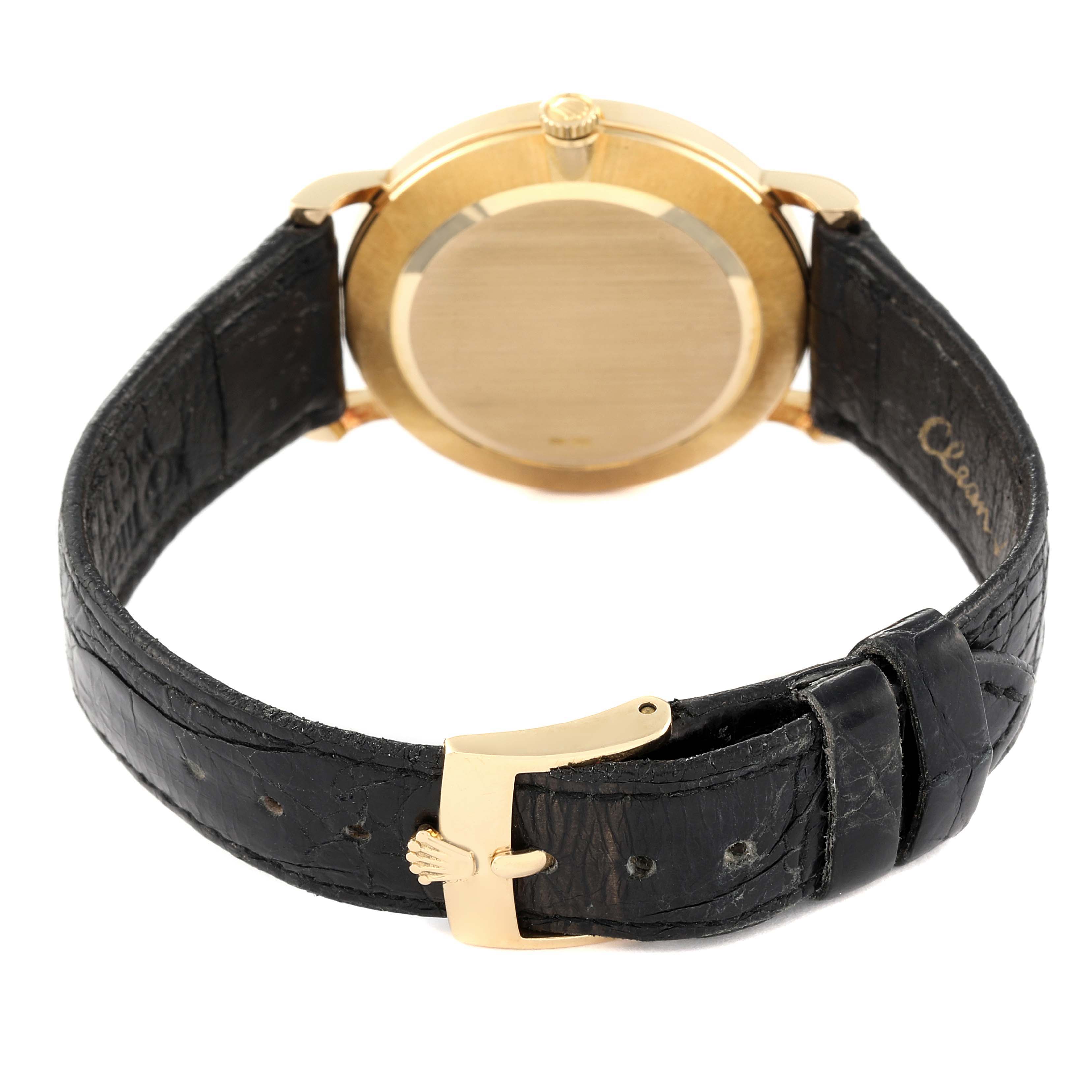 The image shows the back of a Rolex Cellini 5112 Men's Yellow Gold Champagne Dial 5112 Men's Yellow Gold Champagne Dial watch with a gold case and black leather strap.