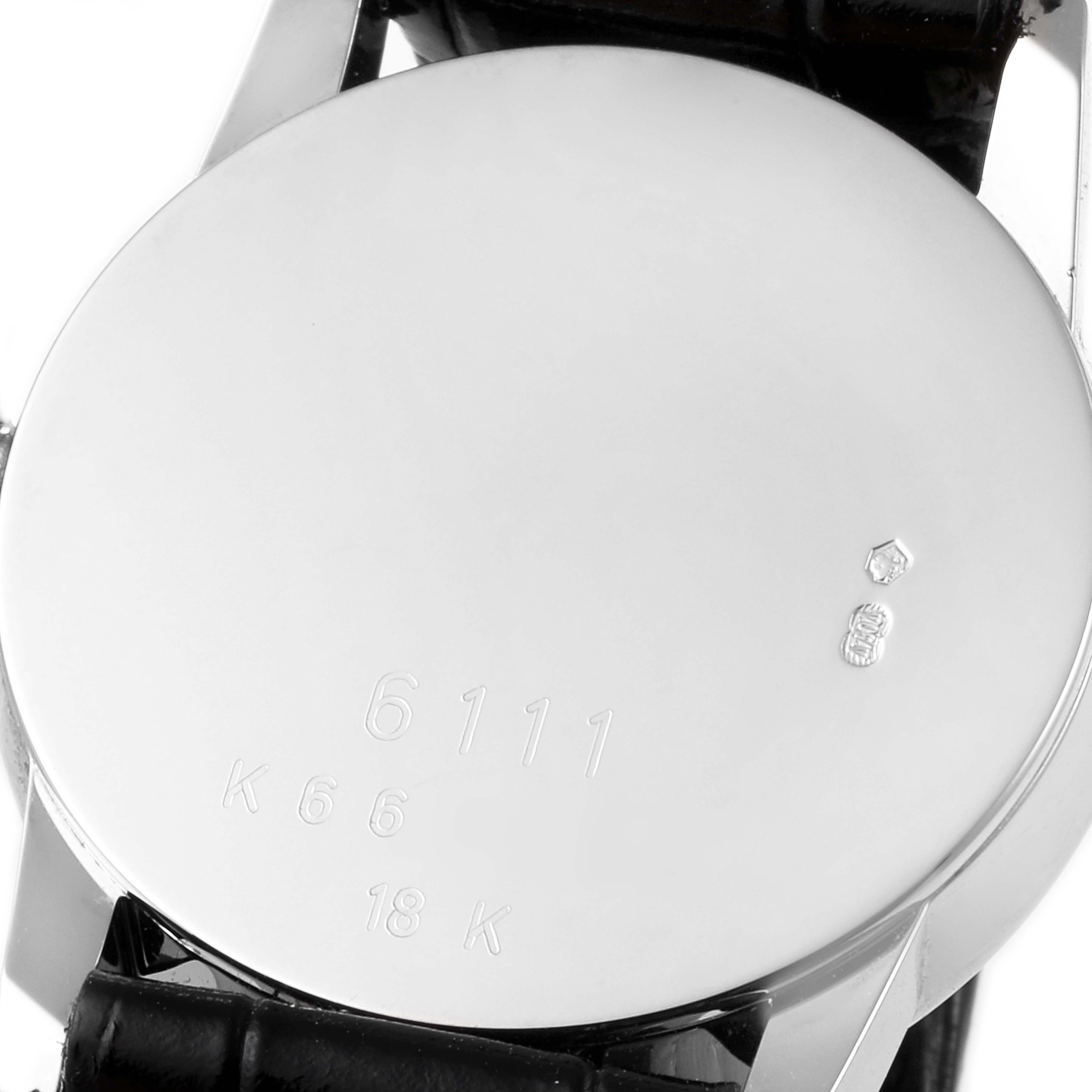 The image shows the back of a Rolex Cellini 6111 Women's White Gold Silver Dial 6111 Women's White Gold Silver Dial, including the caseback with engravings and part of the leather strap.