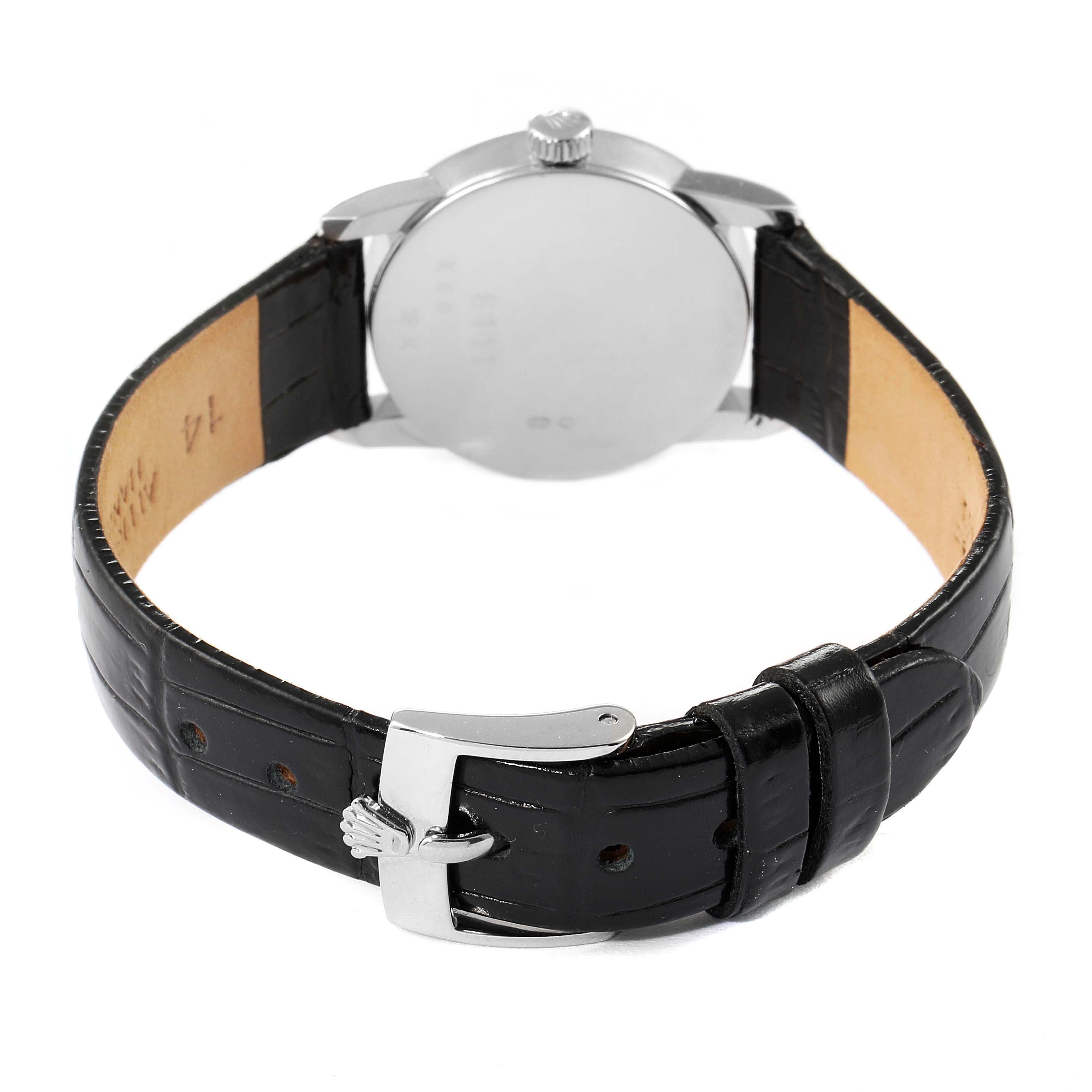 This image shows the back view of a Rolex Cellini 6111 Women's White Gold Silver Dial 6111 Women's White Gold Silver Dial watch, highlighting its case back, crown, and leather strap with clasp.