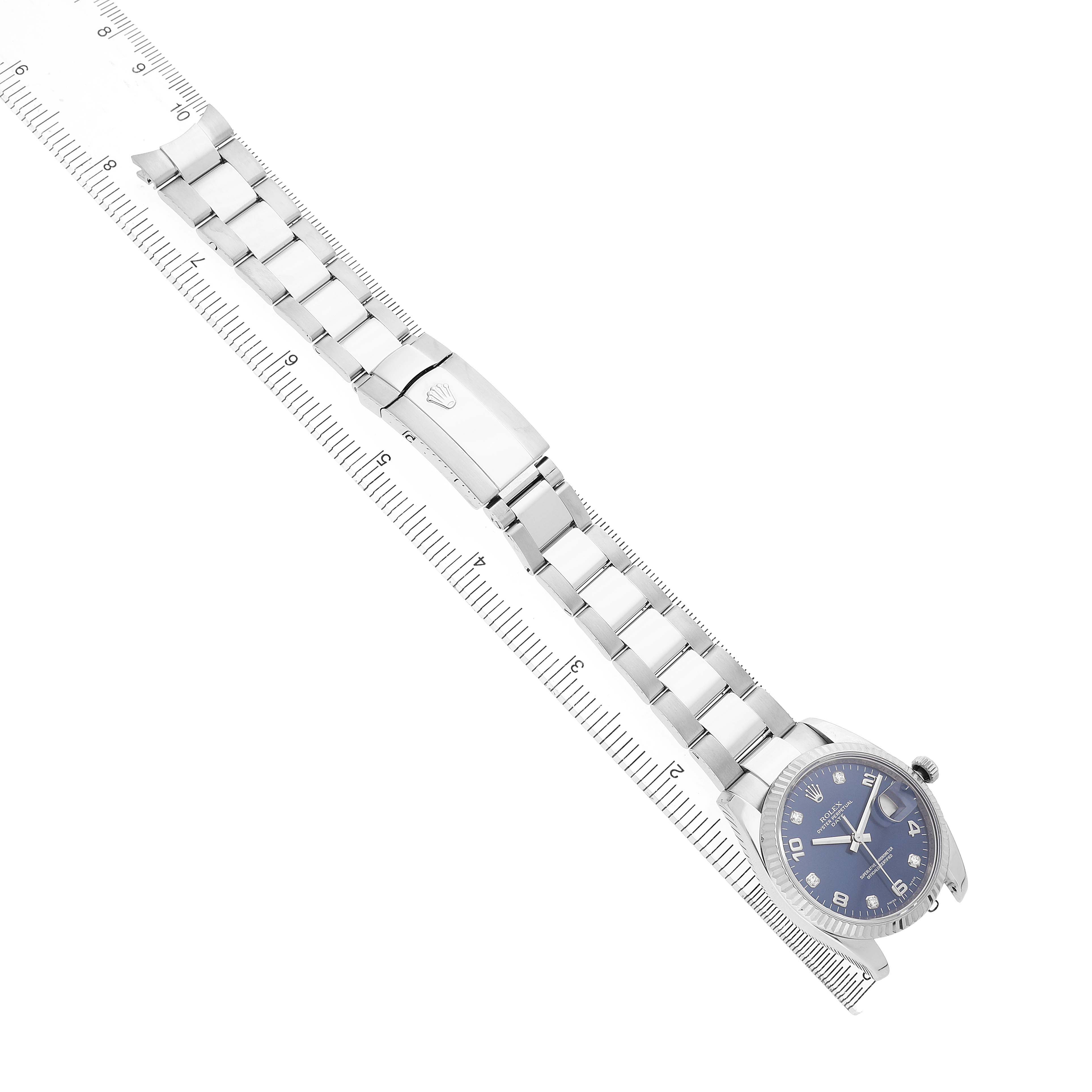 The Rolex Date 115234 Men's Stainless Steel Blue Dial watch is shown from above, featuring its bracelet, clasp, and blue dial.