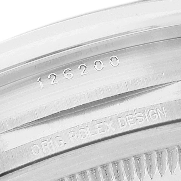 This image shows the edge of the caseback of the Rolex Datejust 126200 Men's Stainless Steel Black Dial 126200 Men's Stainless Steel Black Dial, featuring its reference number and "ORIG. ROLEX DESIGN."