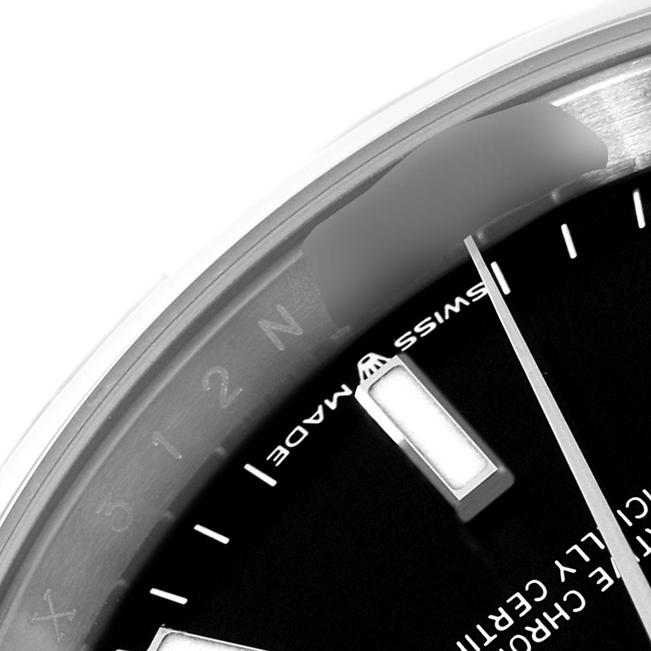 This is a close-up of the dial and bezel of a Rolex Datejust 126200 Men's Stainless Steel Black Dial 126200 Men's Stainless Steel Black Dial watch, showing a portion of the hour markers and the "Swiss Made" text.