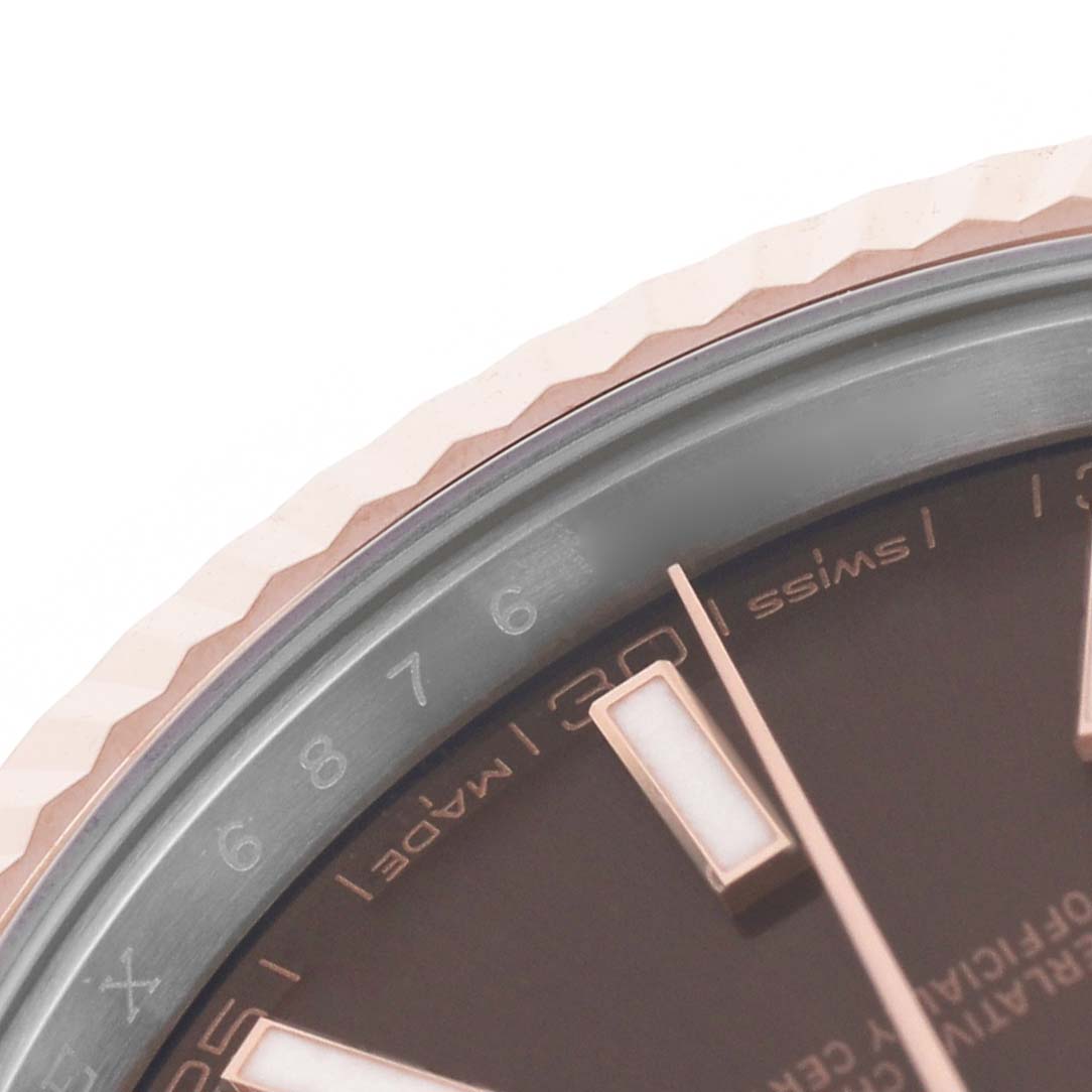 The image shows a close-up of the bezel and part of the dial of a Rolex Datejust 41 126331 Men's Steel and Gold (two tone) Brown Dial watch, featuring rose gold accents.