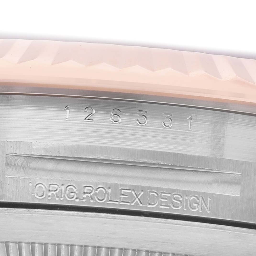 The image shows a close-up of the bezel and case edge of a Rolex Datejust 41 126331 Men's Steel and Gold (two tone) Brown Dial, highlighting engraved model and design marks.