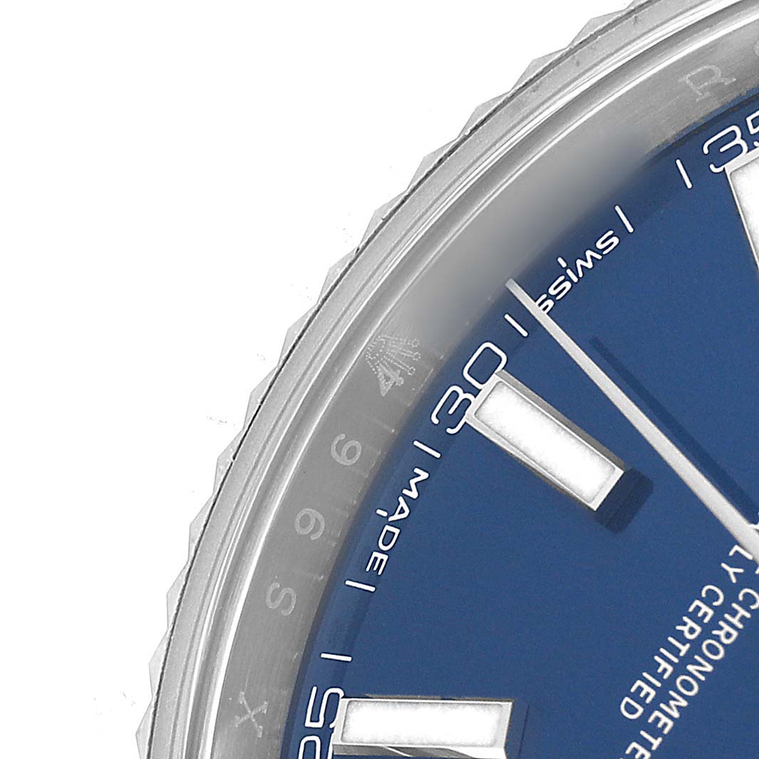 The image shows a close-up of the bezel, chapter ring, and part of the blue dial of the Rolex Datejust 41 126334 Men's Stainless Steel Blue Dial.