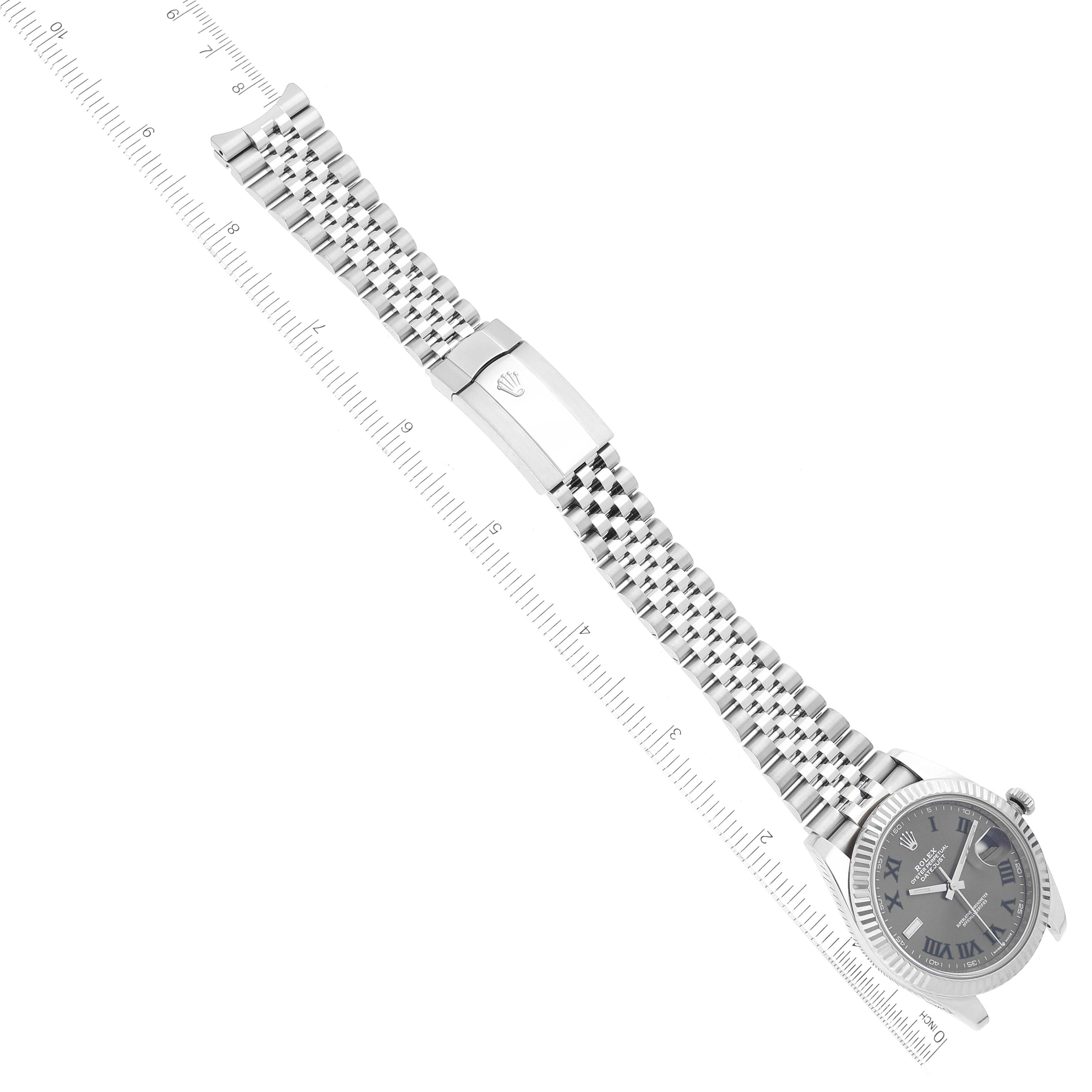 This image shows a top-down view of a Rolex Datejust 41 126334 Men's Stainless Steel Grey Dial 126334 Men's Stainless Steel Grey Dial watch, featuring its face, bracelet, and clasp placed over a ruler.