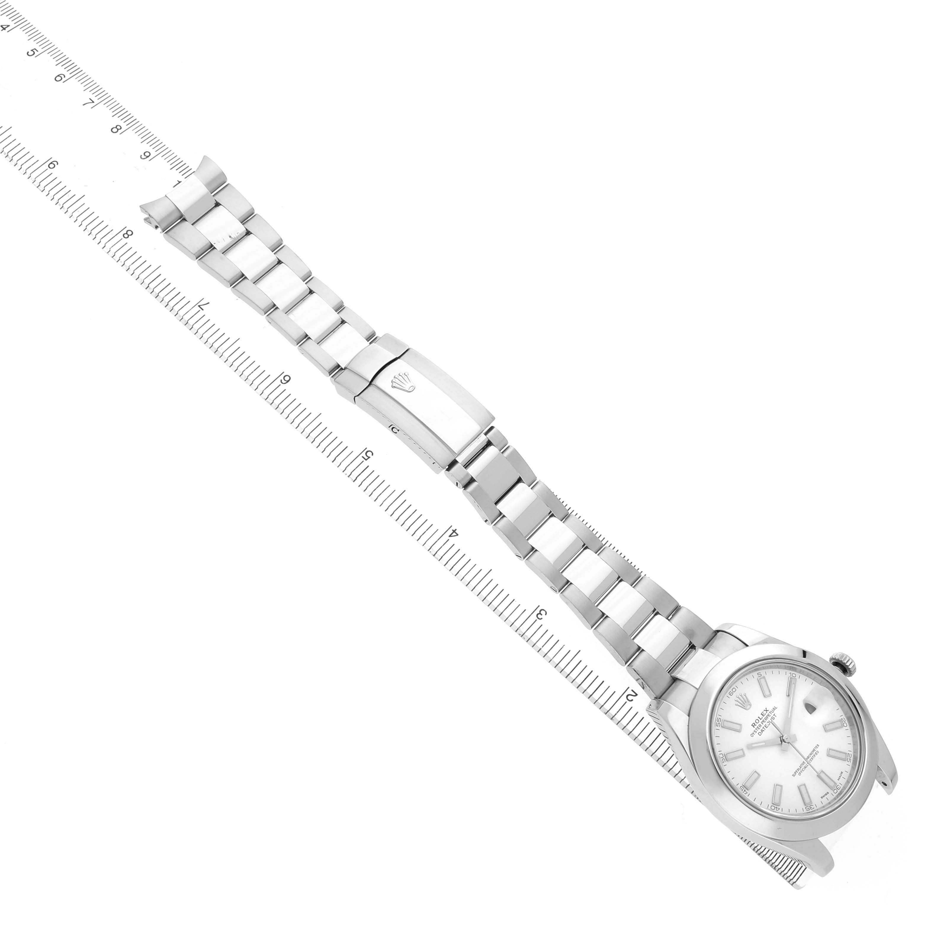 The Rolex Datejust 41 116300 Men's Stainless Steel White Dial is shown from a top-down angle, featuring the full watch band and clasp alongside a ruler for scale.