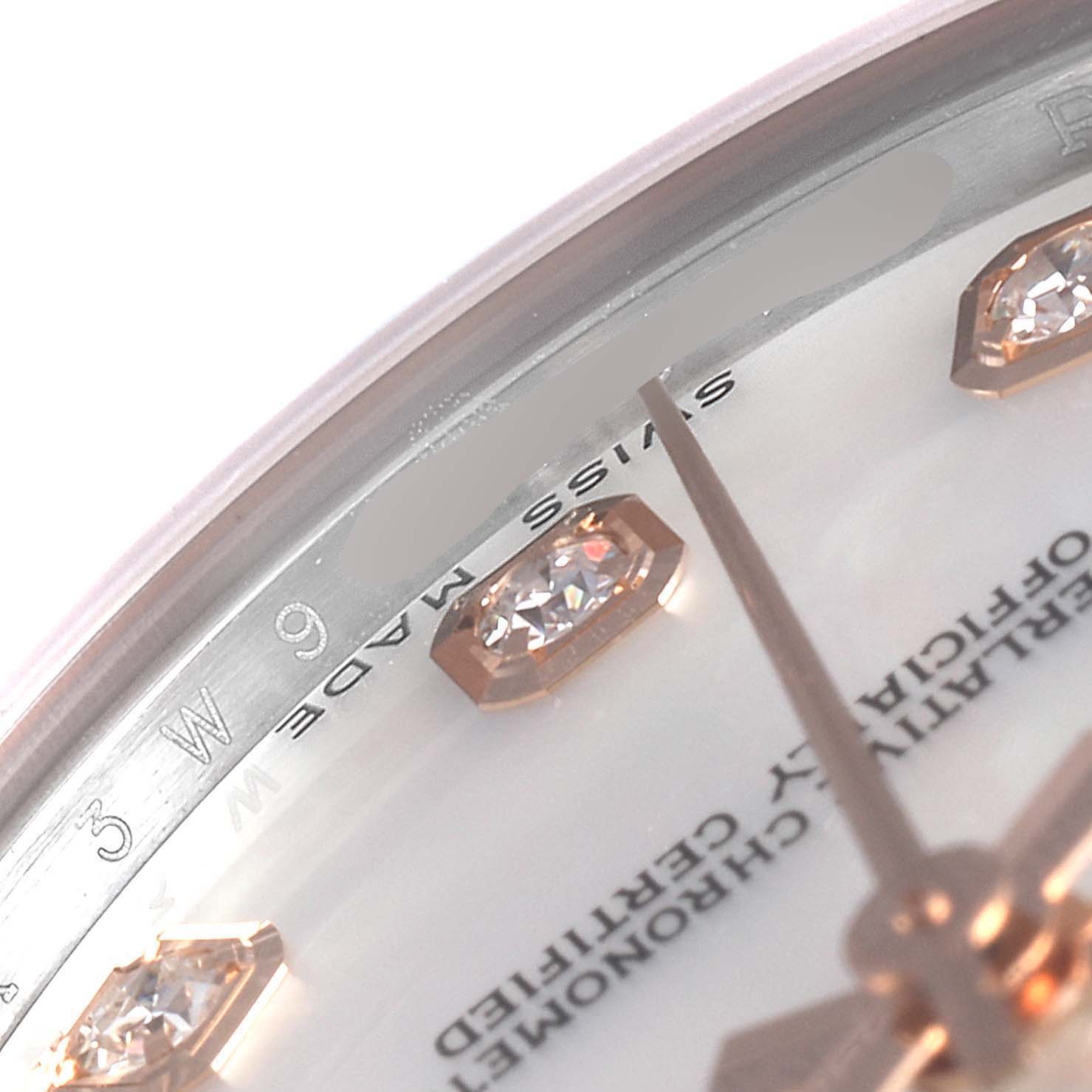 This close-up angle shows details of the dial and diamond hour markers of a Mid-Size Rolex watch.