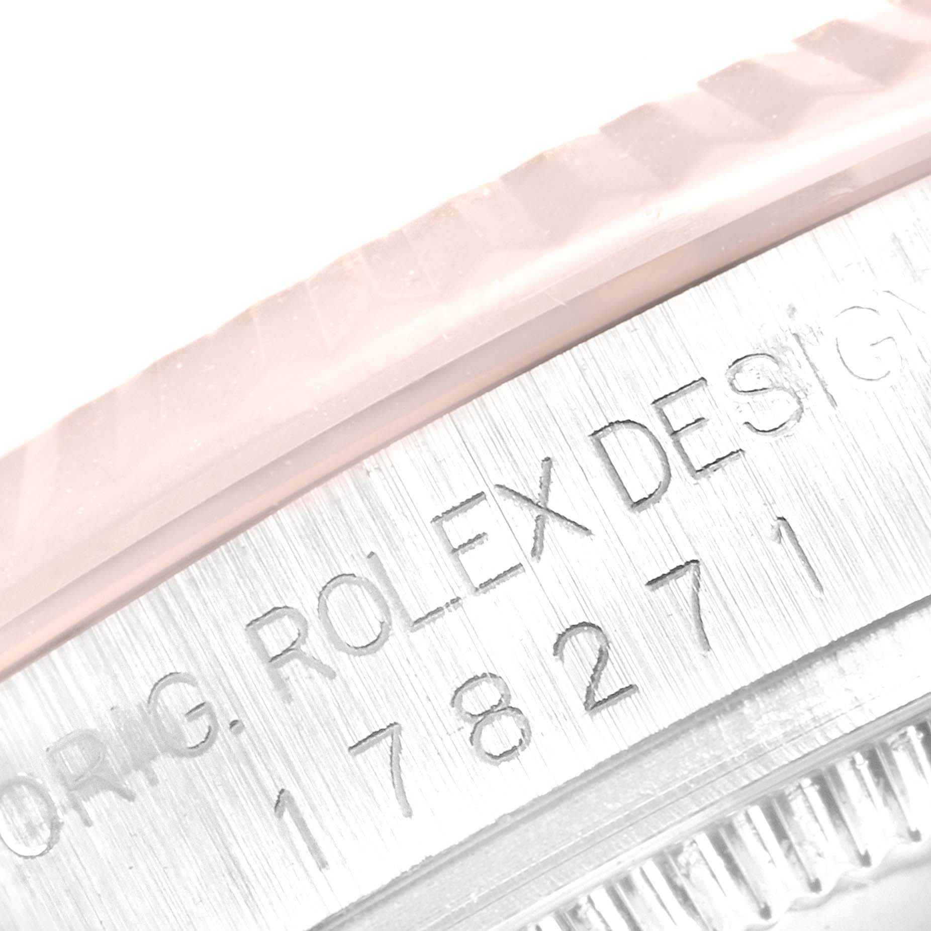This close-up angle shows the engraved serial number and the "ROLEX DESIGN" text on the side of the Mid-Size Rolex watch case.