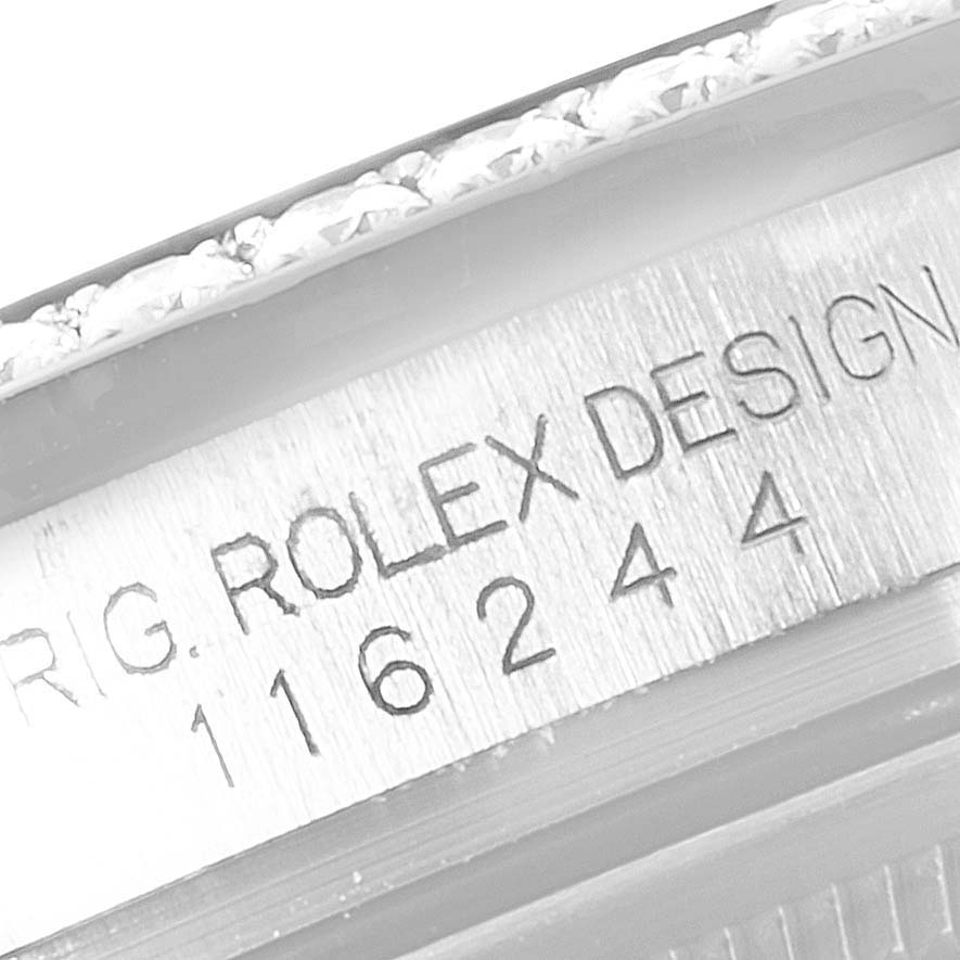 This close-up image shows the engraved serial number and part of the bezel on a Rolex Datejust 116244 Men's Stainless Steel Mother of Pearl Dial 116244 Men's Stainless Steel Mother of Pearl Dial model.