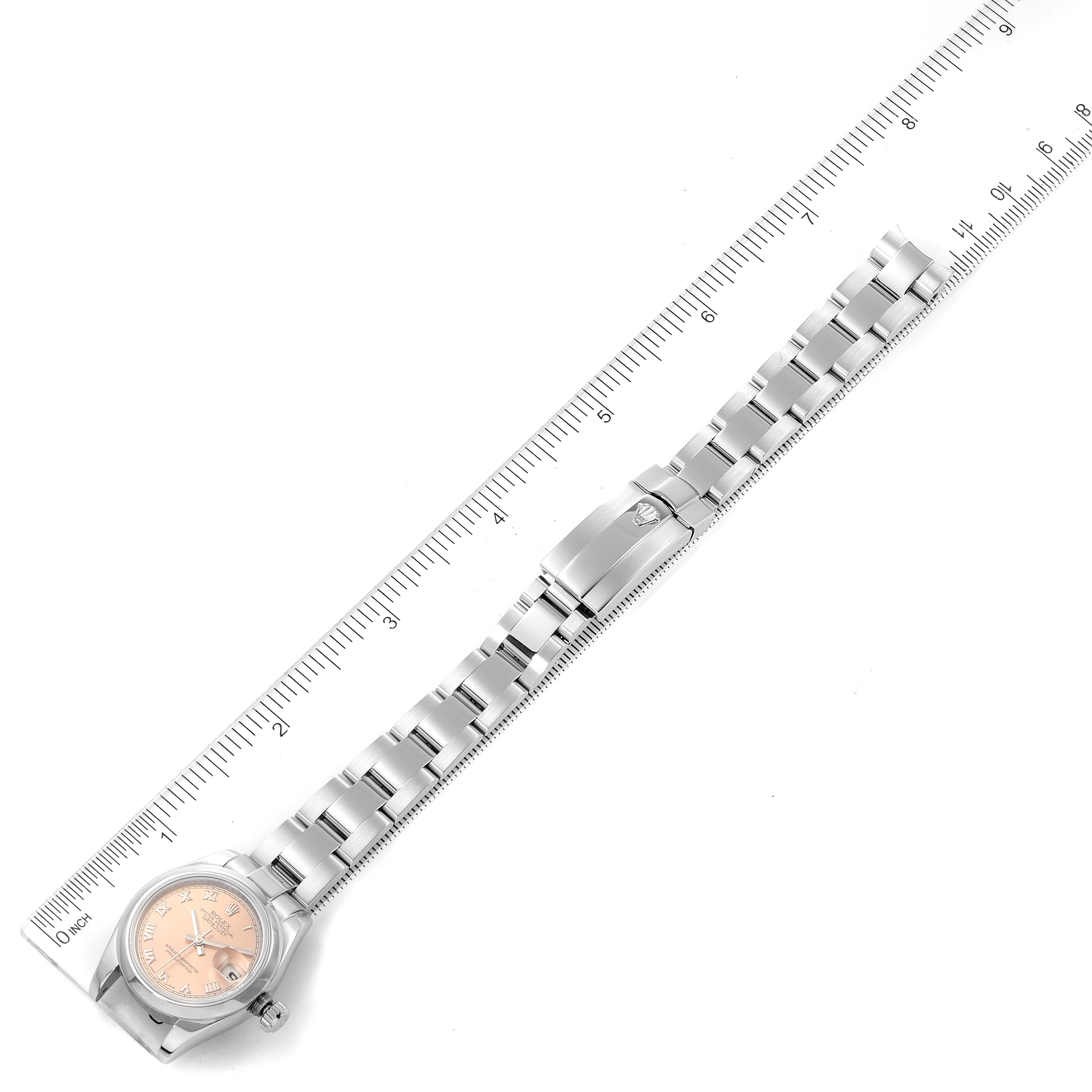 The Rolex Datejust 179160 Women's Stainless Steel Pink Dial 179160 Women's Stainless Steel Pink Dial watch is shown fully extended with a ruler beside it, displaying its band and face from above.