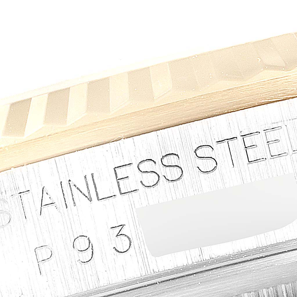 This image shows a close-up angle of the bezel and part of the casing of a Rolex Datejust 16233 Men
s Steel and Gold (two tone) Champagne Dial 16233 Men
s Steel and Gold (two tone) Champagne Dial watch, highlighting "Stainless Steel" text.