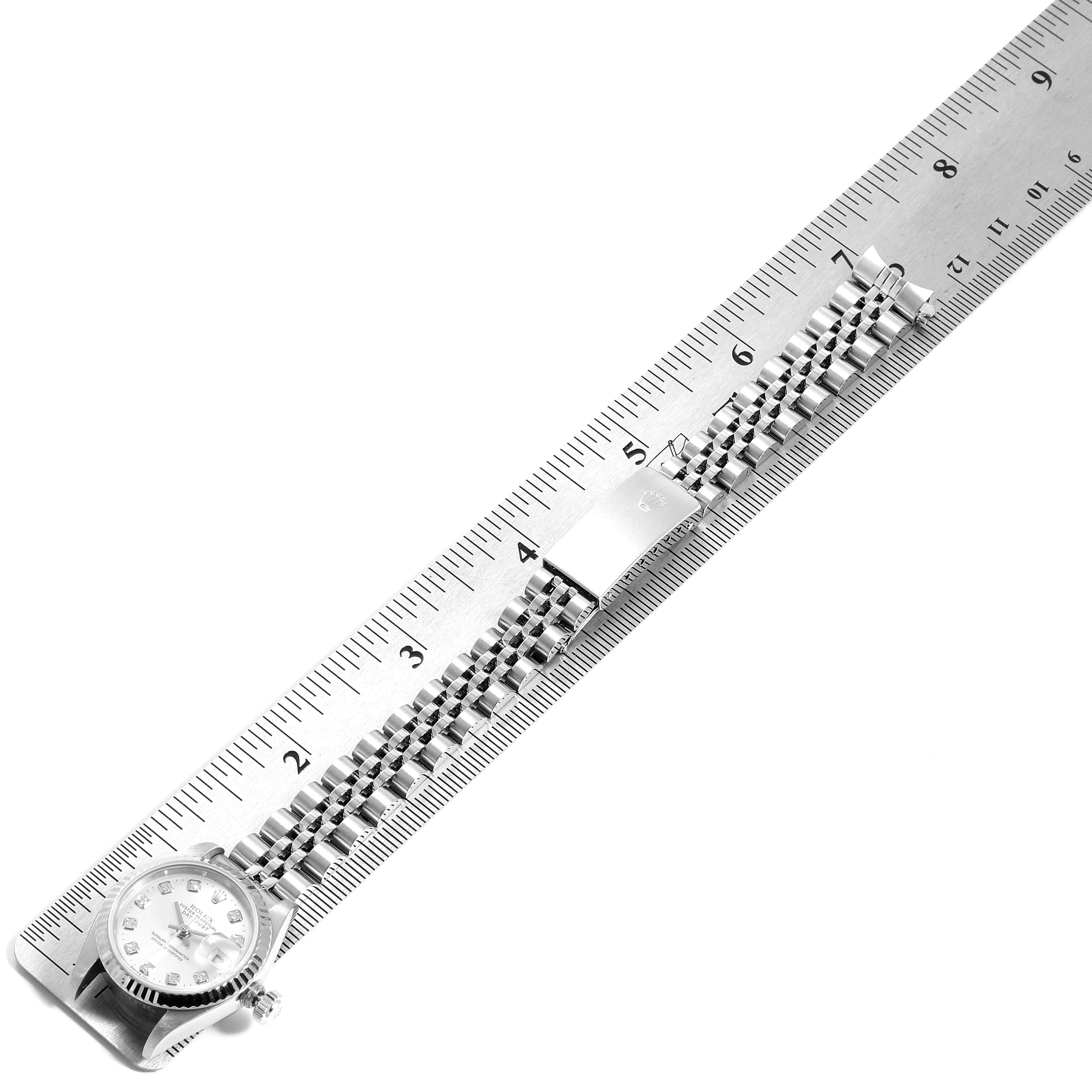 The image shows a side view of a Rolex Datejust 69174 Women
s Stainless Steel Silver Dial 69174 Women
s Stainless Steel Silver Dial watch placed along a ruler, highlighting the bracelet and clasp.
