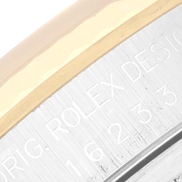 The image shows a close-up of the side casing and engraved details of a Rolex Datejust 16233 Men's Steel and Gold (two tone) Champagne Dial 16233 Men's Steel and Gold (two tone) Champagne Dial watch.