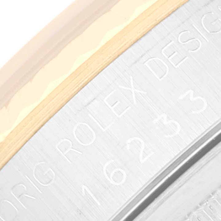 The image shows a close-up angle of the Rolex Datejust 16233 Men's Steel and Gold (two tone) Champagne Dial 16233 Men's Steel and Gold (two tone) Champagne Dial model's case back with engraved text.