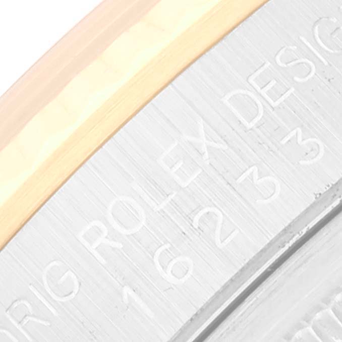 This close-up image shows the edge of the back case and the serial number engraving on a Rolex Datejust 16233 Men's Steel and Gold (two tone) Beige Dial 16233 Men's Steel and Gold (two tone) Beige Dial watch.