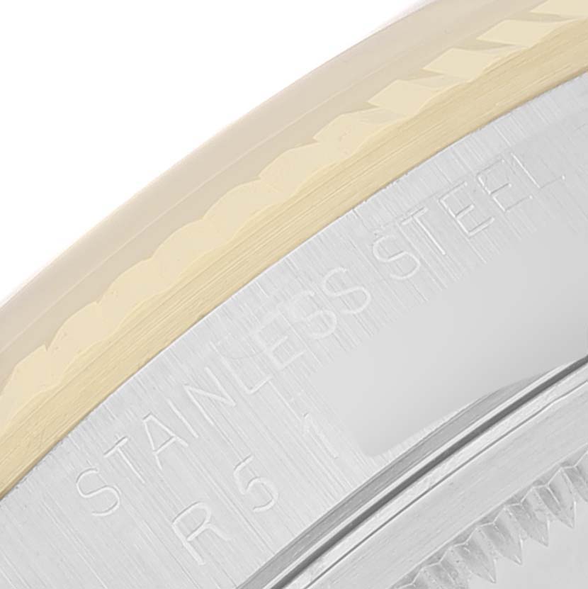 The image shows a close-up of the side profile of a Rolex Datejust 16233 Men's Steel and Gold (two tone) Beige Dial 16233 Men's Steel and Gold (two tone) Beige Dial watch, highlighting its stainless steel and fluted bezel.