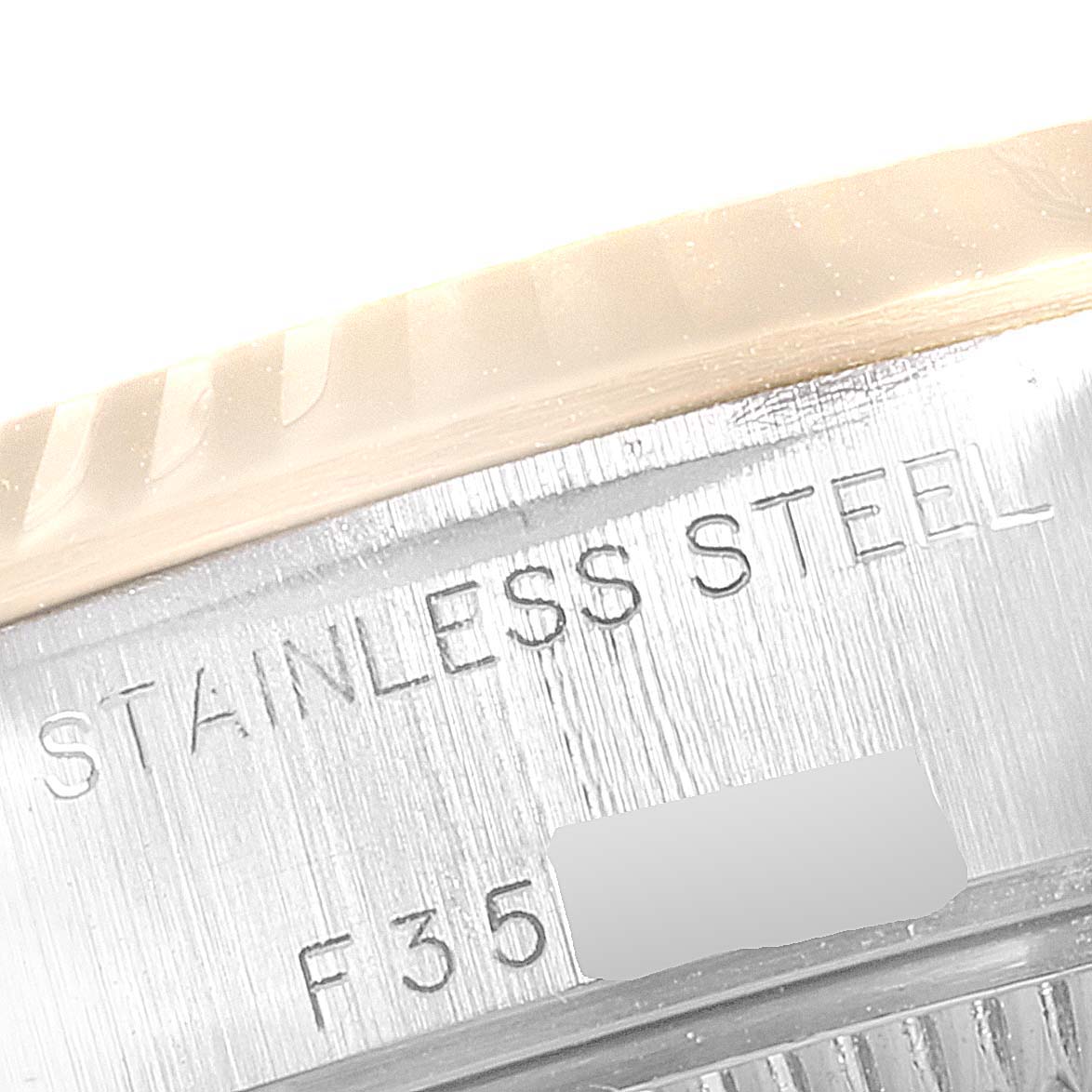 This close-up view of a Rolex Datejust 79173 Women
s Steel and Gold (two tone) Mother of Pearl Dial 79173 Women
s Steel and Gold (two tone) Mother of Pearl Dial watch shows the stainless steel engraving on its case.