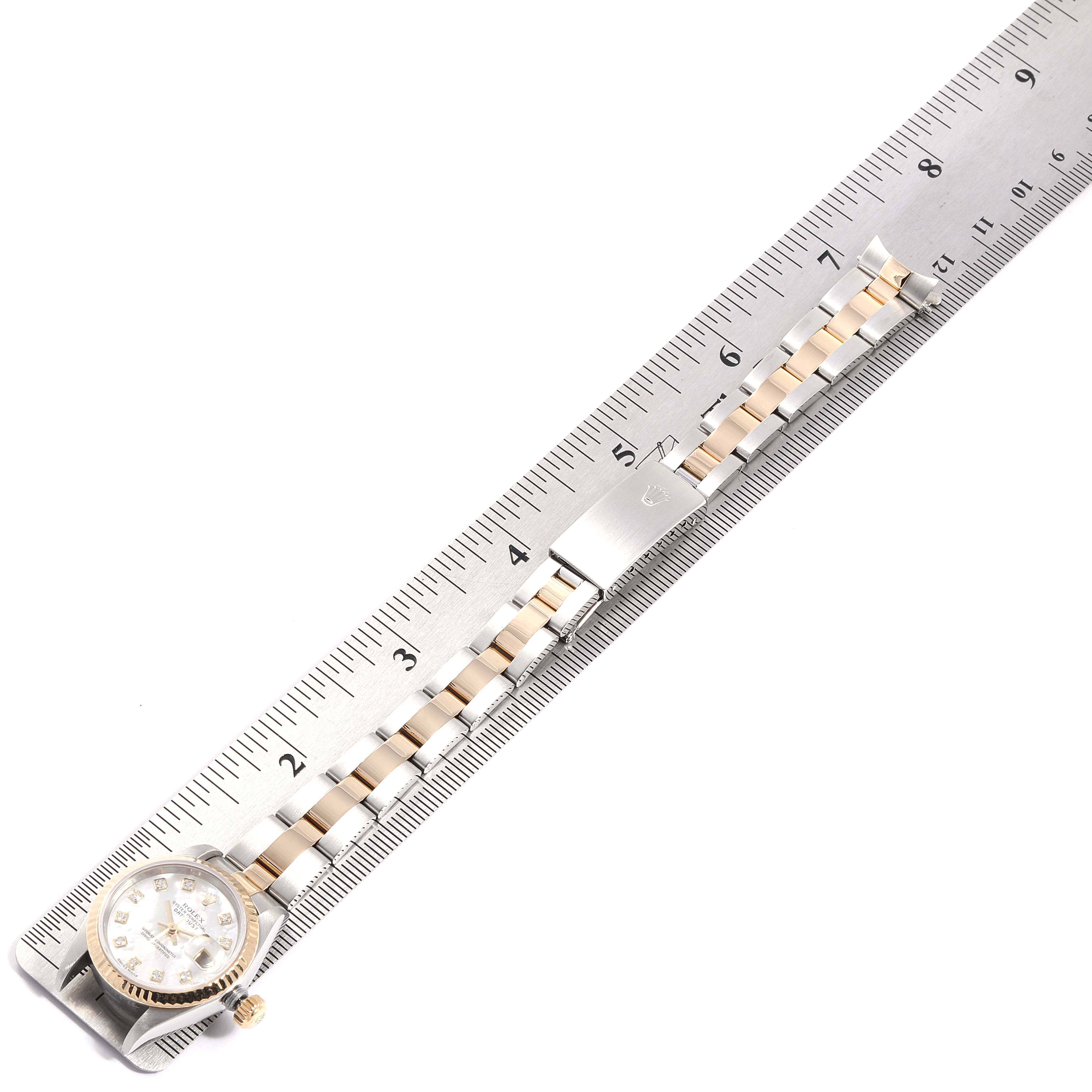 The Rolex Datejust 79173 Women
s Steel and Gold (two tone) Mother of Pearl Dial 79173 Women
s Steel and Gold (two tone) Mother of Pearl Dial watch is displayed laid flat, showing the dial, bezel, crown, and stainless-steel with gold link bracelet.