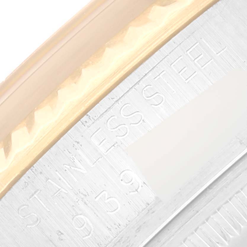 This is a close-up of the stainless steel and gold bezel with engraved text on a Rolex Datejust 16013 Men's Steel and Gold (two tone) Champagne Dial 16013 Men's Steel and Gold (two tone) Champagne Dial watch.