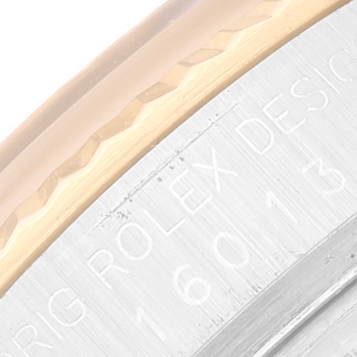 This close-up image shows the bezel and part of the engraved casing back of a Rolex Datejust 16013 Men's Steel and Gold (two tone) Champagne Dial 16013 Men's Steel and Gold (two tone) Champagne Dial watch.
