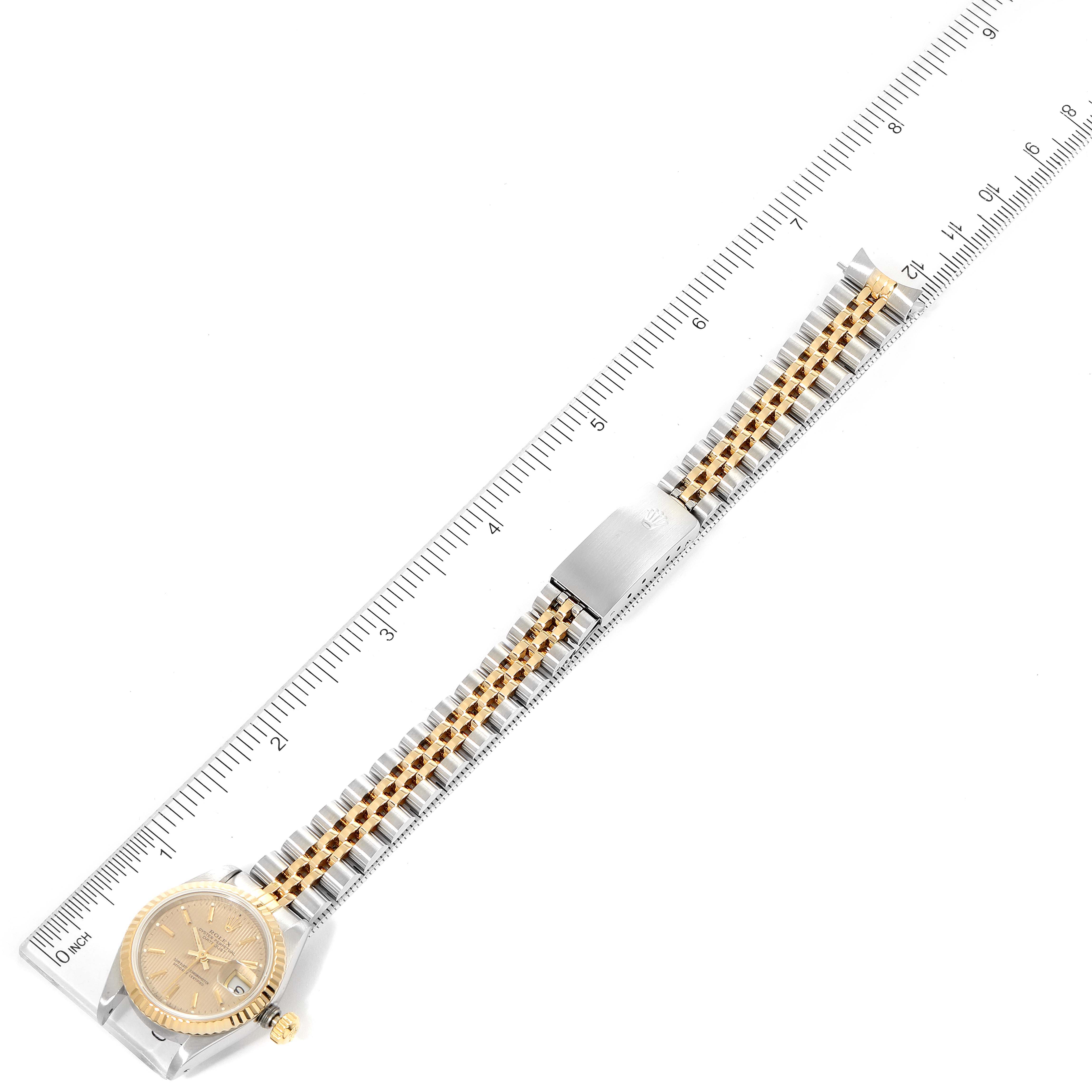 The Rolex Datejust 69173 Women
s Steel and Gold (two tone) Champagne Dial 69173 Women
s Steel and Gold (two tone) Champagne Dial watch is shown from an overhead angle, displaying the face, bracelet, and clasp with measurements.