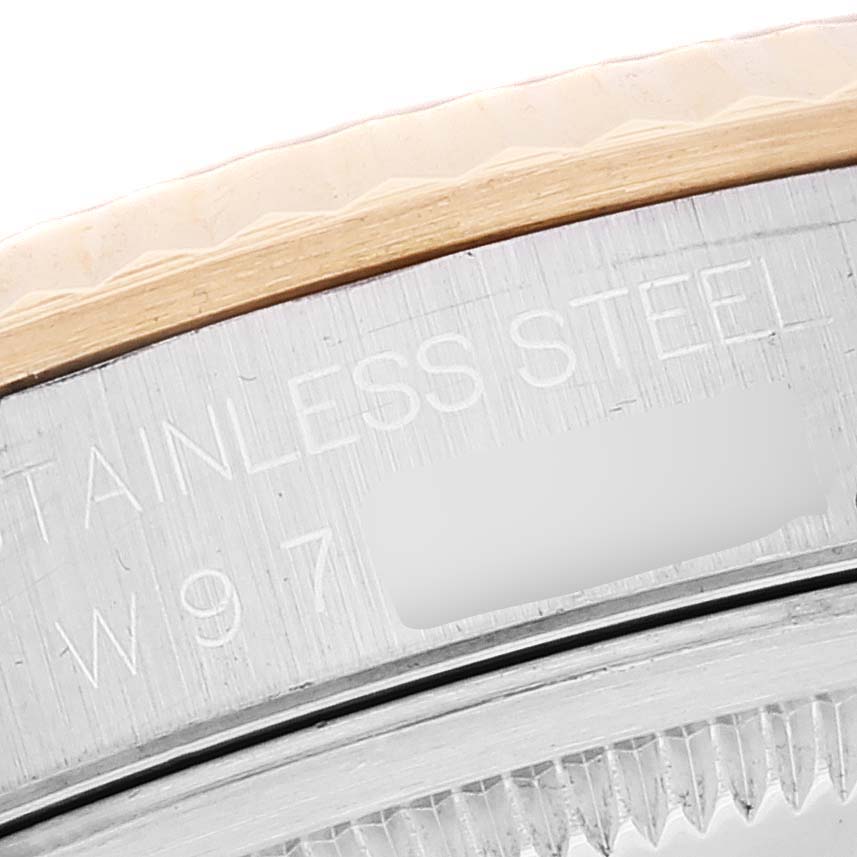 This image shows a close-up of the bezel and outer case back of a Rolex Datejust 16233 Men's Steel and Gold (two tone) White Dial 16233 Men's Steel and Gold (two tone) White Dial watch, featuring the engraving "STAINLESS STEEL".