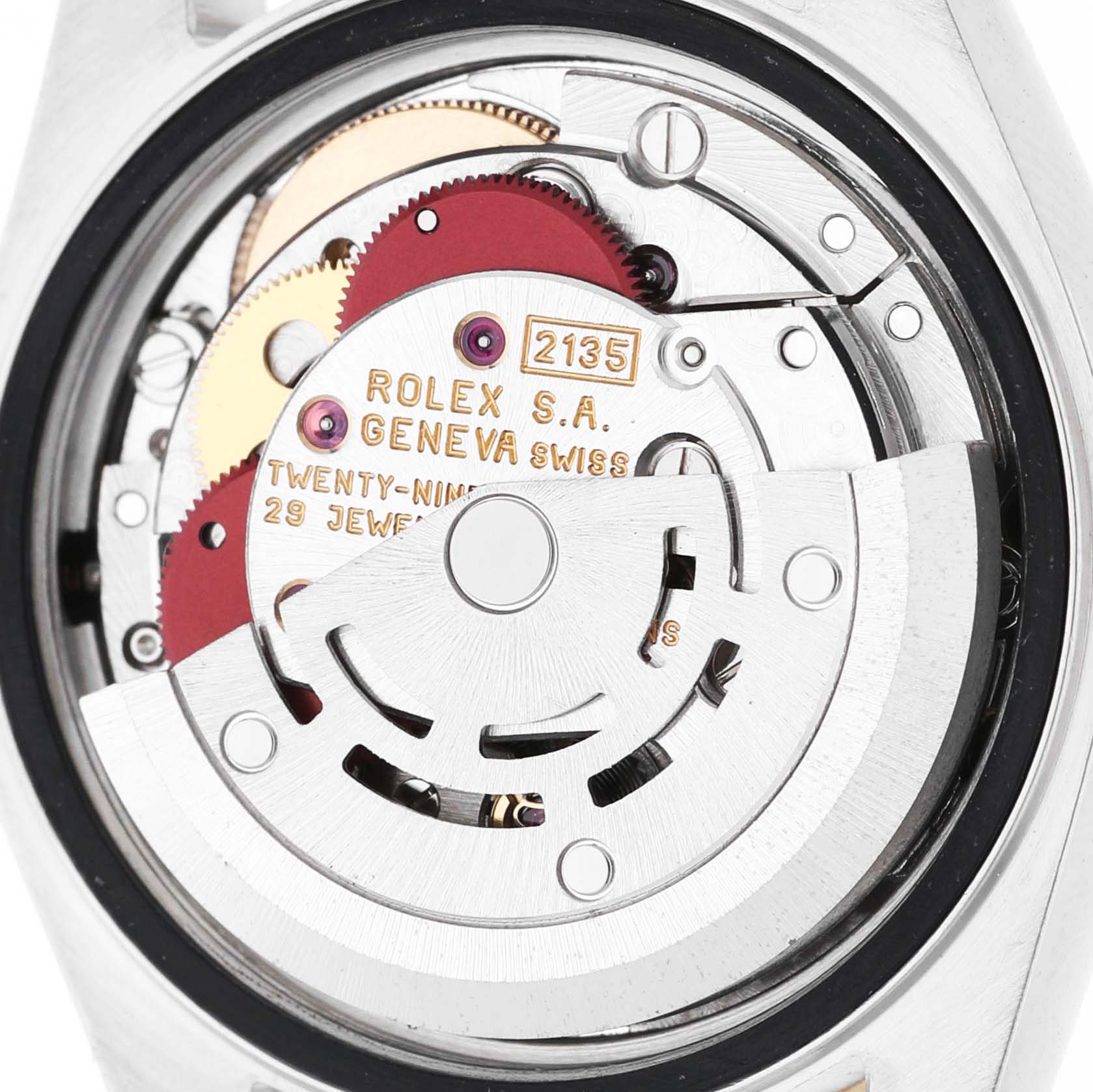 The image shows the movement from the back of a Rolex Datejust 69173 Women's Steel and Gold (two tone) White Dial watch, revealing intricate gears and engravings.