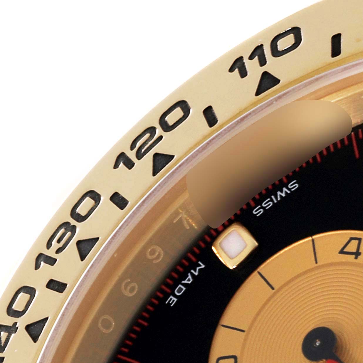 The image shows a close-up of the bezel and part of the dial of a Rolex Daytona 116508 Men's Yellow Gold Black Dial 116508 Men's Yellow Gold Black Dial watch.